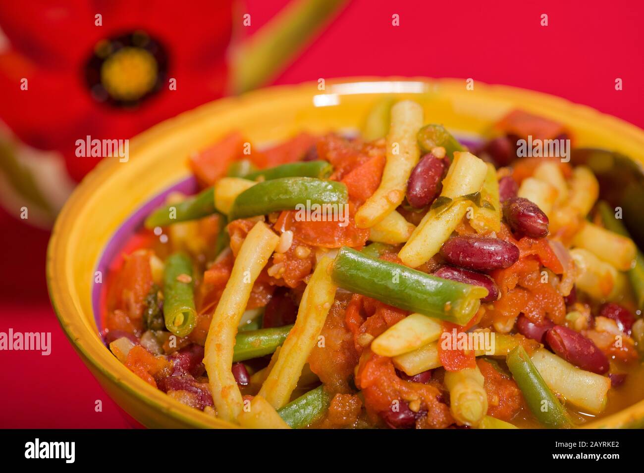 In una ciotola, herbed tre fagioli con pomodori, contenenti fagioli verdi, fagioli di cera gialla e fagioli di rene Foto Stock