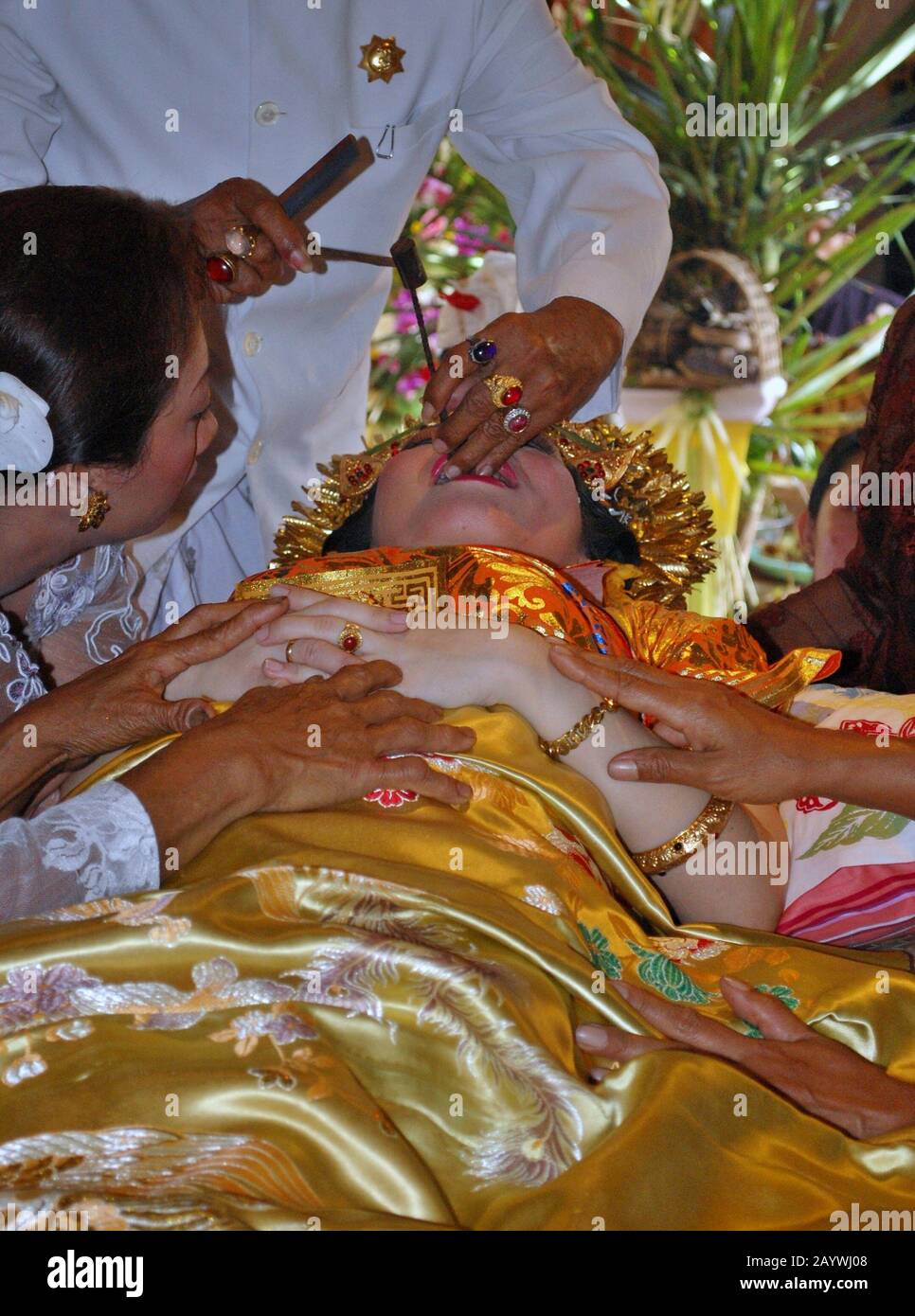 Una donna Balinese e' su un rituale dei denti di taglio. Il taglio dei denti e' un tradizionale rituale Balinese come segno della maturità di una donna Balinese. Foto Stock