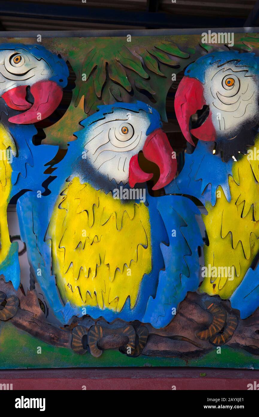 Colorate opere d'arte in metallo che raffigurano i pappagalli su una parete di un ristorante nella città di Loreto, Mare di Cortez, Baja California, Messico. Foto Stock