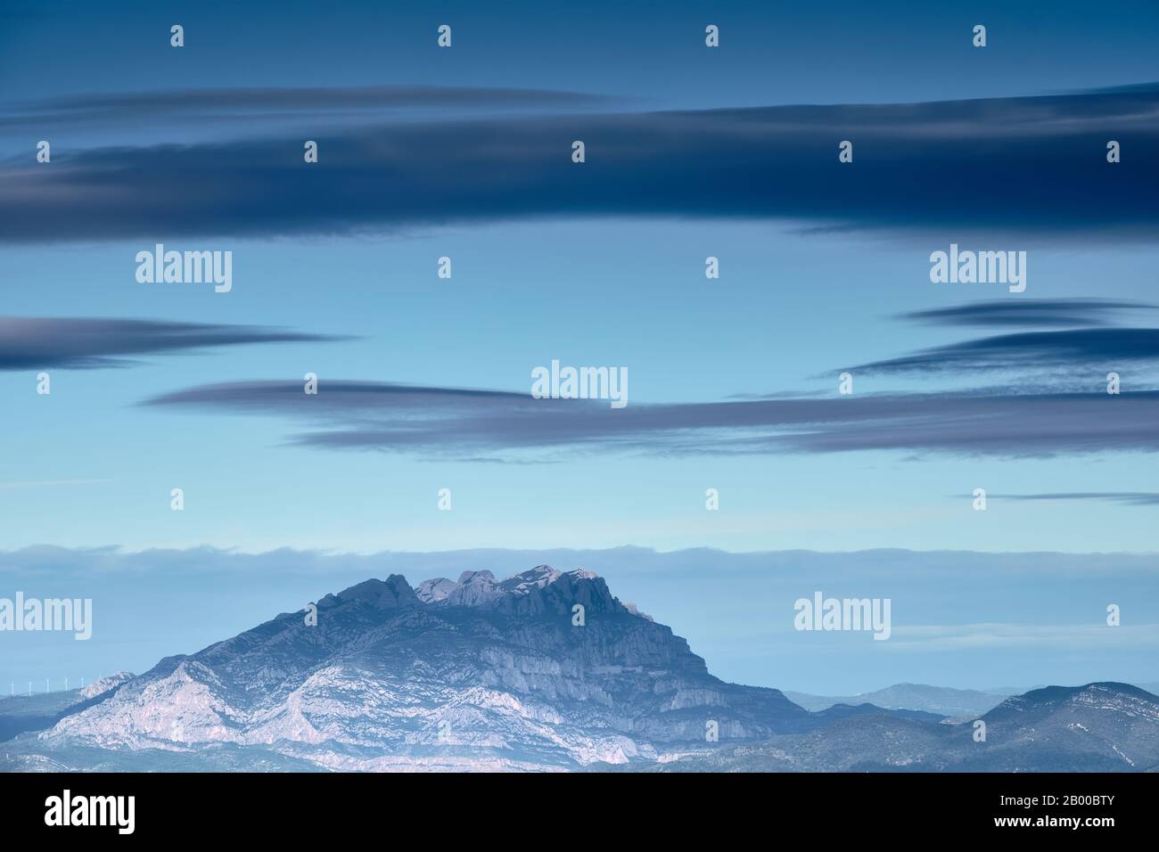 Montagna di granito con atmosfera blu e grandi nuvole, Montserrat, Catalogna Foto Stock