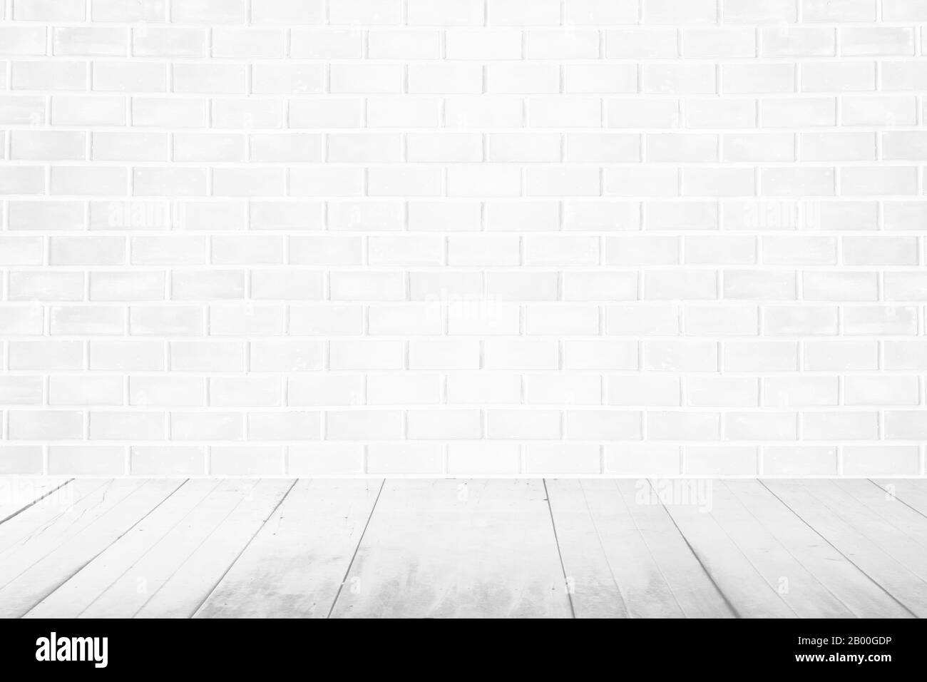 camera d'epoca interna vuota con pareti in mattoni bianchi e pavimento in legno bianco Foto Stock