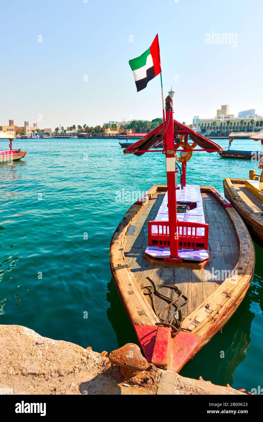 Imbarcazione tradizionale abra con bandiera degli Emirati Arabi Uniti e Dubai Creek (traghetto tra il quartiere di Deira e Bur Dubai), Emirati Arabi Uniti Foto Stock