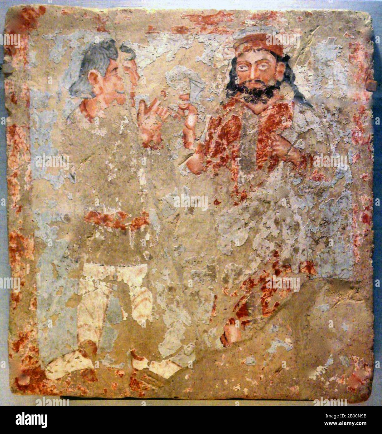 Afghanistan: Zeus/Serapis/Ohrmazd con l'adoratore di Kushan, Bactria, III secolo d.C. L'impero kushan originariamente formato nell'inizio del primo secolo d.C. sotto il principe Kujula Kadphises nell'antica Bactria su entrambi i lati del fiume Oxus in quello che ora è l'Afghanistan settentrionale, e Tagikistan meridionale e Uzbekistan. Durante il primo e l'inizio del secondo secolo CE, i Kushani si espansero rapidamente attraverso la parte settentrionale del subcontinente indiano almeno fino a Saketa e Sarnath vicino a Varanasi (Benares). Foto Stock