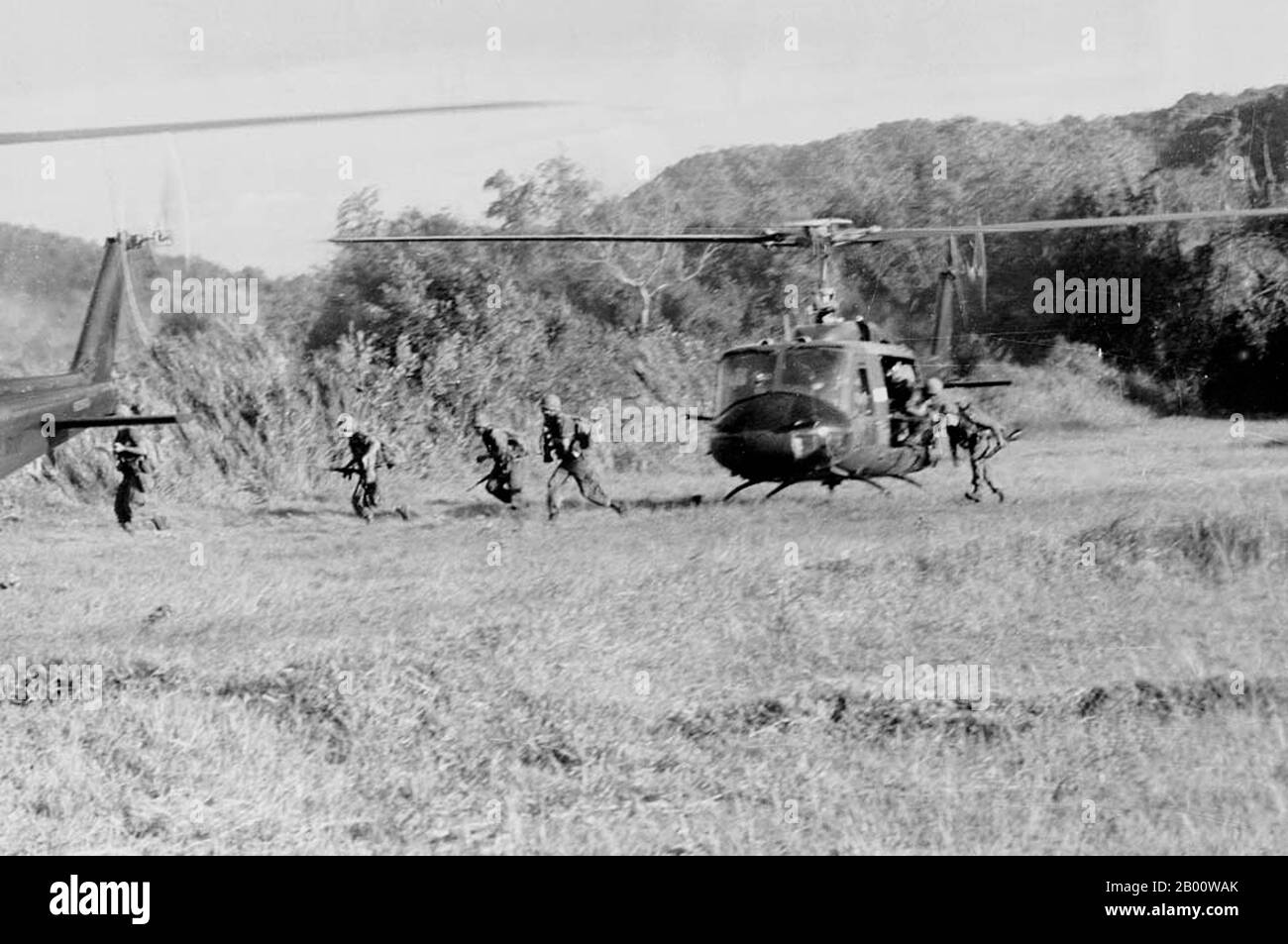 Vietnam: Forze aeree STATUNITENSI che si dismontano dagli elicotteri durante le fasi iniziali della battaglia per la Valle di Ia Drang, 1965. La Valle di Ia Drang è una valle situata vicino a PLEIKU, nelle Highlands centrali del Vietnam. Il 14 novembre 1965, 450 soldati americani della prima Divisione di Cavalleria aerea sono stati sollevati in elicottero a questa valle con l'intenzione di localizzare ed eliminare le forze nord vietnamite. Questi soldati americani erano quasi immediatamente circondati da oltre 2,000 soldati dell'Esercito popolare del Vietnam (PAVN, conosciuto anche come Esercito del Nord Vietnamita) che arrivavano in onde. Foto Stock