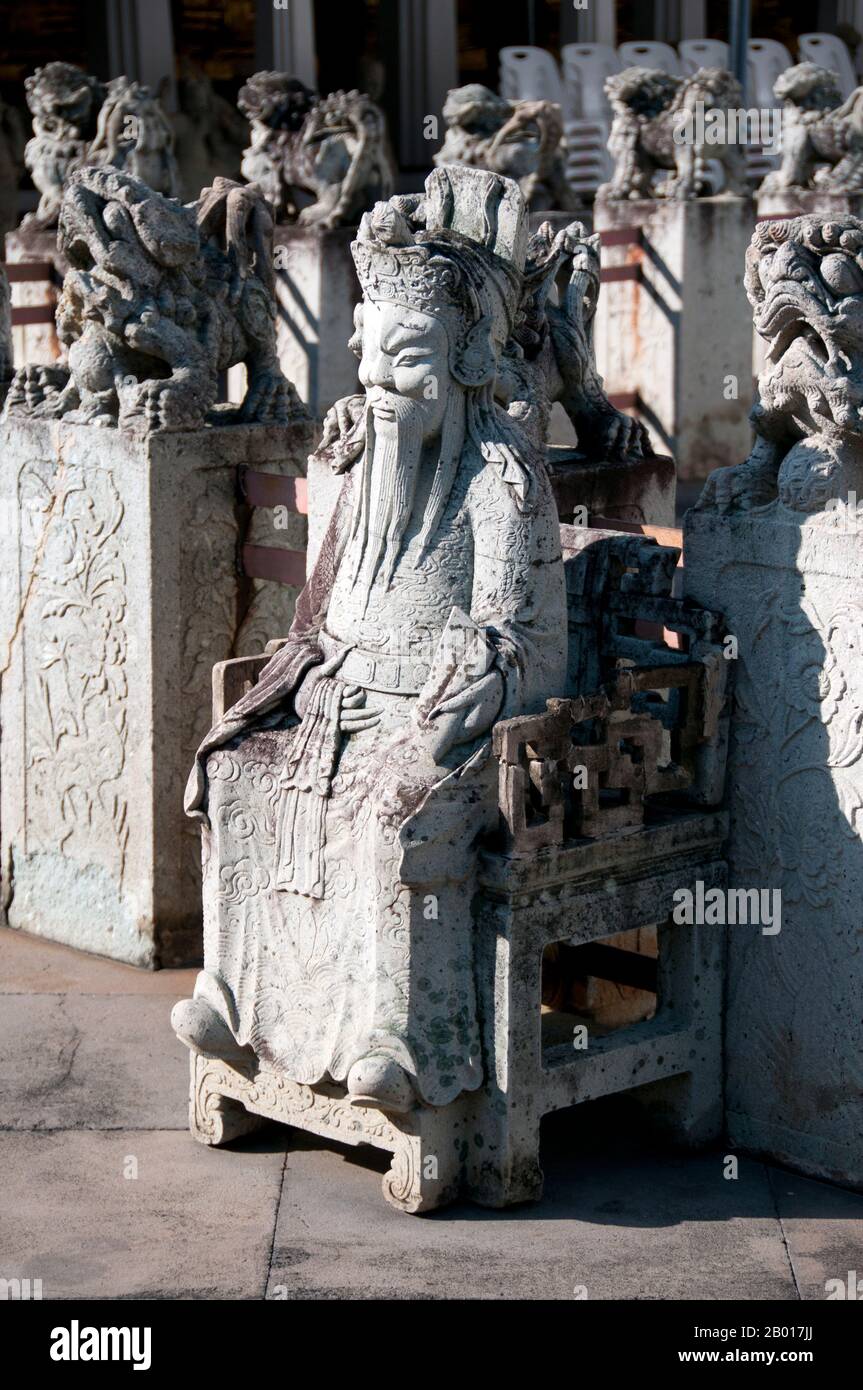 Thailandia: Figura cinese nel complesso principale del tempio, Wat Arun (Tempio dell'alba), Bangkok. Wat Arun Rajwararam (Tempio dell'alba), nome completo Wat Arunratchawaram Ratchahawihan, è un tempio buddista tailandese sulla riva occidentale del fiume Chao Phraya a Bangkok. Prende il nome da Aruna, il Dio indiano dell'alba. Un monastero si trova qui fin dal periodo Ayutthayan (1351 - 1767), ma la caratteristica principale del tempio, il prang centrale in stile Khmer, fu iniziata solo nel 1809, durante il regno del re Buddha Loetla Nabhalai (Rama II). Foto Stock