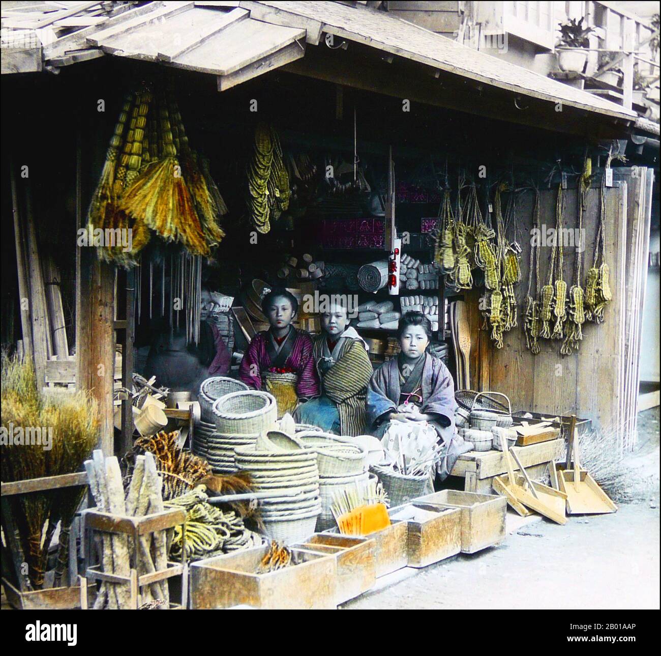 Giappone: Tre donne sedute all'ingresso di un negozio di merci in attesa di clienti. Foto di T. Enami (1859-1929), c.. 1895. T. Enami (Enami Nobukuni) era il nome commerciale di un celebre fotografo del periodo Meiji. Il T. del suo nome commerciale è pensato per essere stato per Toshi, anche se non ha mai scritto fuori su qualsiasi documento personale o di affari. Nato a Edo (ora Tokyo) durante l'era Bakumatsu, Enami fu prima studente di, e poi assistente del noto fotografo e collotipista, Ogawa Kazumasa. Enami si è rilocato a Yokohama e ha aperto uno studio a Benten-dōri (via Benten). Foto Stock