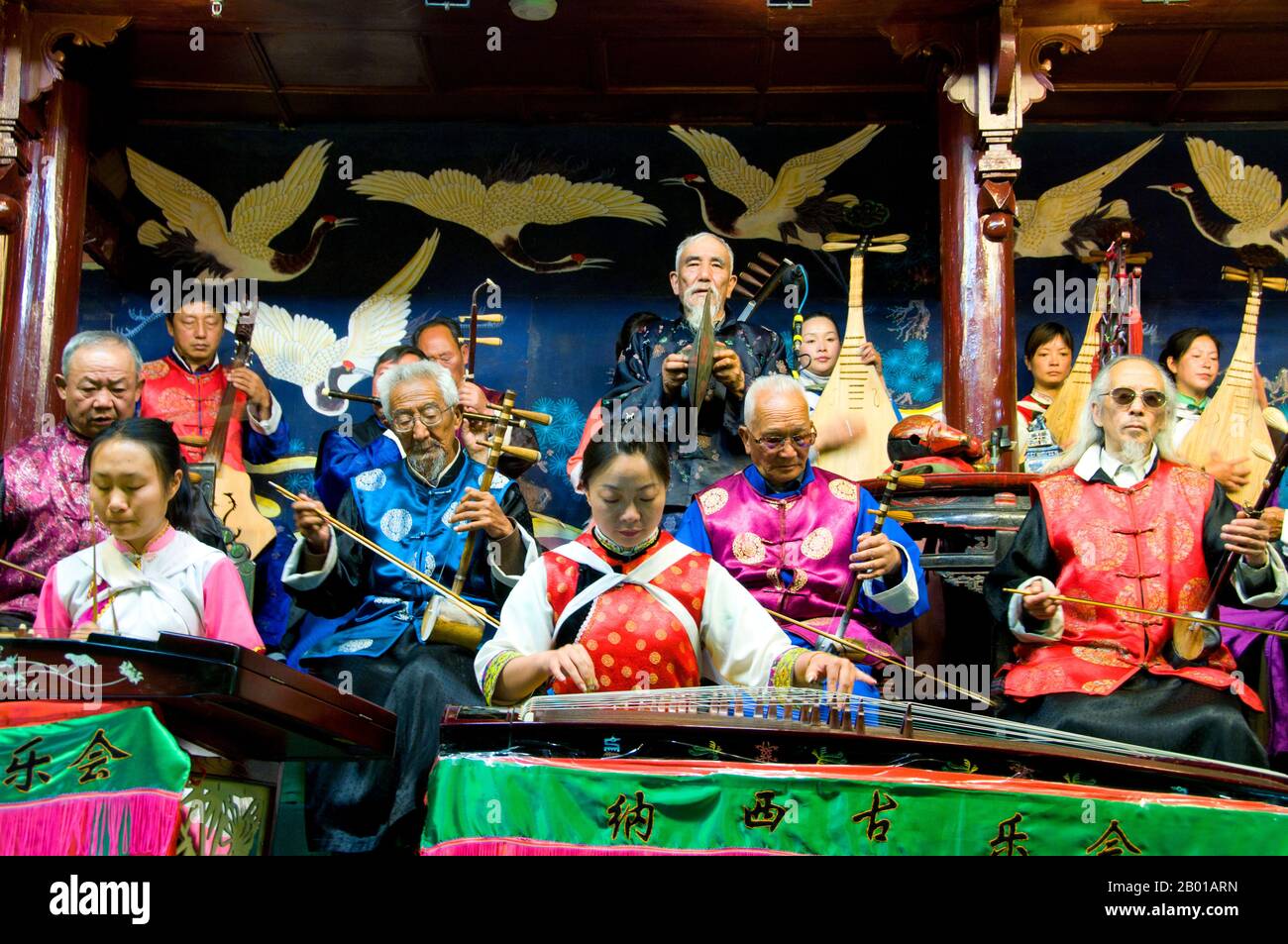 Cina: Orchestra folk di Naxi (Nakhi), Sala dell'Orchestra di Naxi, Città Vecchia di Lijiang, Provincia di Yunnan. La musica Naxi ha 500 anni e con la sua miscela di testi letterari, argomenti poetici e stili musicali delle dinastie Tang, Song e Yuan, così come alcune influenze tibetane, ha sviluppato il suo stile e i suoi tratti unici. Ci sono tre stili principali: Baisha, Dongjing e Huangjing, tutti utilizzando strumenti tradizionali cinesi. I Naxi o Nakhi sono un gruppo etnico che vive ai piedi delle colline dell'Himalaya nella parte nord-occidentale della provincia di Yunnan. Foto Stock