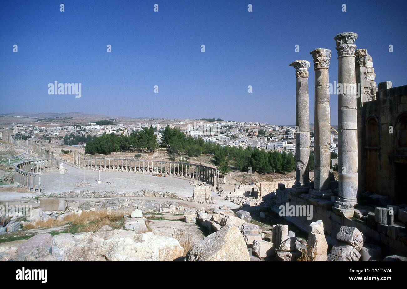 Giordania: Il Tempio di Zeus e il foro ovale nell'antica città greco-romana di Jerash. Jerash è il sito delle rovine della città greco-romana di Gerasa, chiamata anche Antiochia sul fiume d'oro. Jerash è considerata una delle città romane più importanti e meglio conservate del vicino Oriente. Era una città della Decapolis. Recenti scavi mostrano che Jerash era già abitata durante l'età del bronzo (3200-1200 a.C.). Dopo la conquista romana nel 63 a.C. Jerash e le terre circostanti furono annesse dalla provincia romana della Siria, e in seguito si unirono alle città della Decapoli. Foto Stock