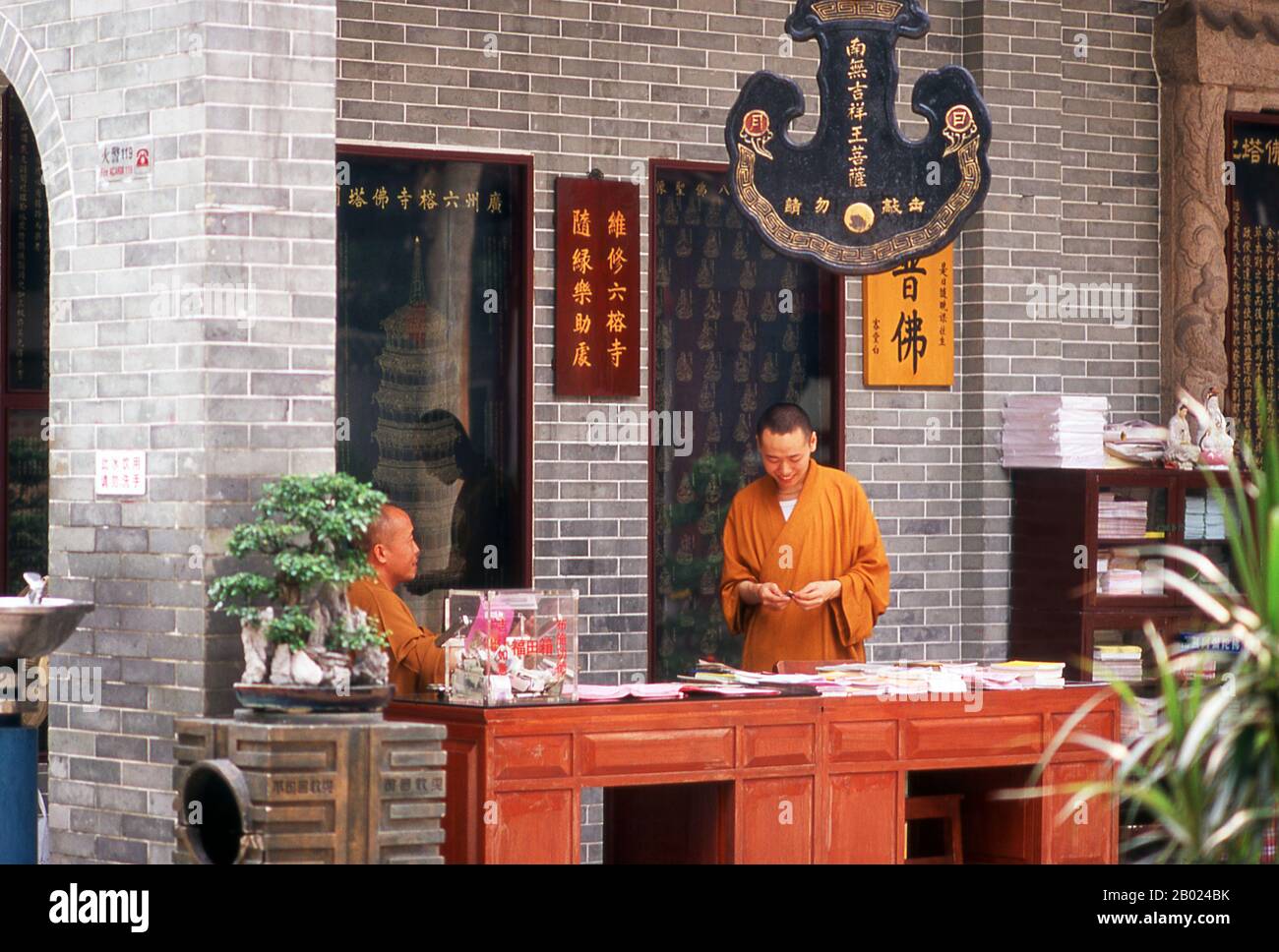 Cina: Monaci al Tempio dei sei alberi di Banyan (Liurongsi), Guangzhou, provincia del Guangdong. Liurong si (Tempio dei sei alberi di Banyan), è stata fondata oltre 1.400 anni fa. Gli alberi che ispirarono il poeta e calligrafo dell'XI secolo su Dongpo a nominare il tempio sono morti da allora. Affacciato su tutto si trova la Hua Ta (Pagoda dei Fiori), una snella reliquia della dinastia Song, costruita nel 1097. Foto Stock