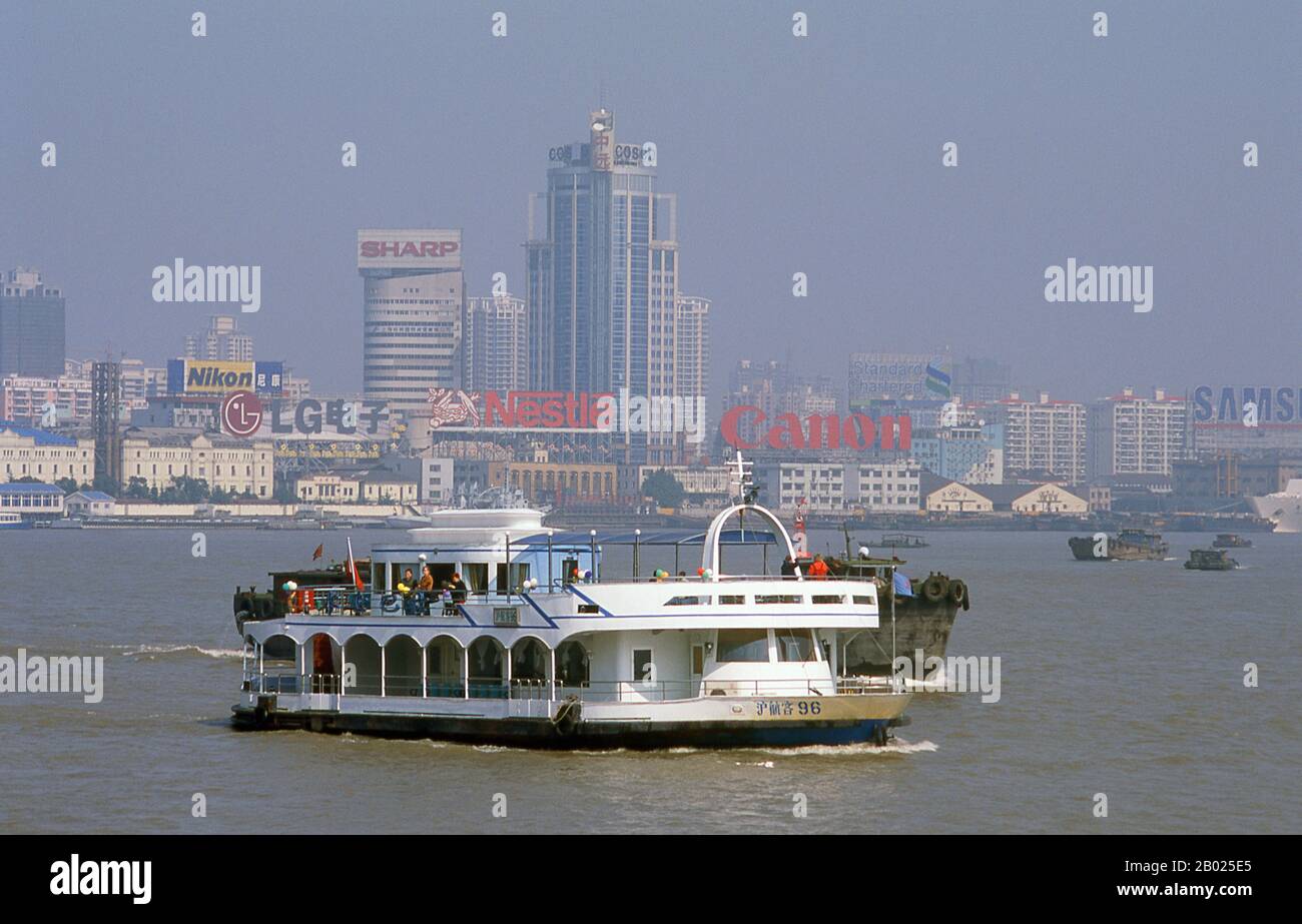 Cina: Nave da crociera su un nebbioso fiume Huangpu, Shanghai, 2000. Shanghai iniziò la sua vita come villaggio di pescatori, e più tardi come porto che riceveva merci trasportate lungo il fiume Yangzi. Dal 1842 in poi, dopo la prima guerra dell'oppio, i britannici aprirono una "concessione" a Shanghai, dove i trafficanti di droga e altri commercianti potevano operare indisturbati. Francesi, italiani, tedeschi, americani e giapponesi seguirono tutti. Negli anni '1920 e '1930, Shanghai era una città boom e una parola d'ordine internazionale per la dissipazione. Quando i comunisti conquistarono il potere nel 1949, trasformarono Shanghai in un modello della rivoluzione. Foto Stock