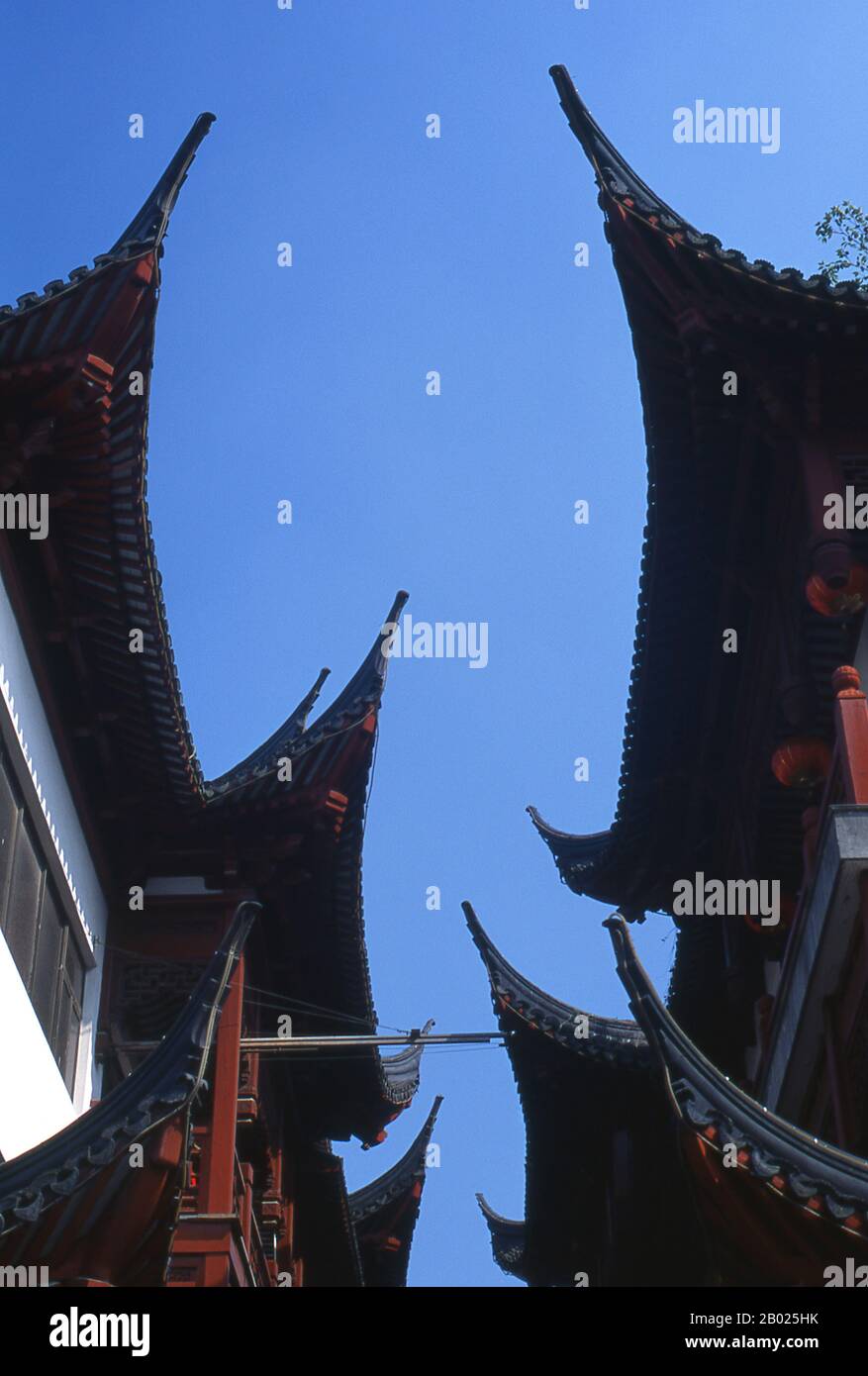Cina: Tetti tradizionali, area del Bazaar Yuyuan, Nanshi o la città Vecchia, Shanghai. Shanghai iniziò la sua vita come villaggio di pescatori, e più tardi come porto che riceveva merci trasportate lungo il fiume Yangzi. Dal 1842 in poi, dopo la prima guerra dell'oppio, i britannici aprirono una "concessione" a Shanghai, dove i trafficanti di droga e altri commercianti potevano operare indisturbati. Francesi, italiani, tedeschi, americani e giapponesi seguirono tutti. Negli anni '1920 e '1930, Shanghai era una città boom e una parola d'ordine internazionale per la dissipazione. Foto Stock