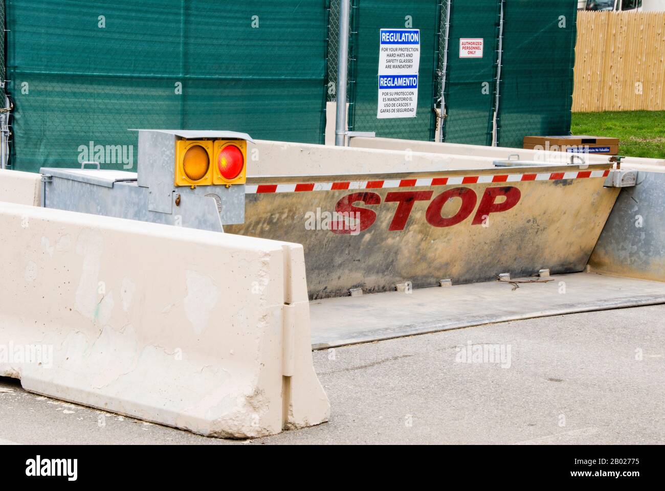 Barricata di cemento pubblica con un segno di arresto e personale autorizzato solo segni. Foto Stock