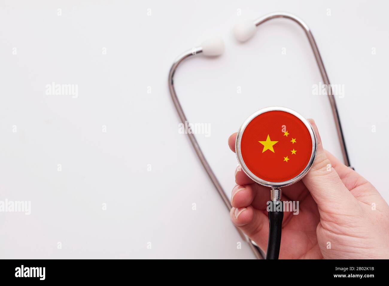 Concetto sanitario cinese. Medico che detiene uno stetoscopio medico. Foto Stock