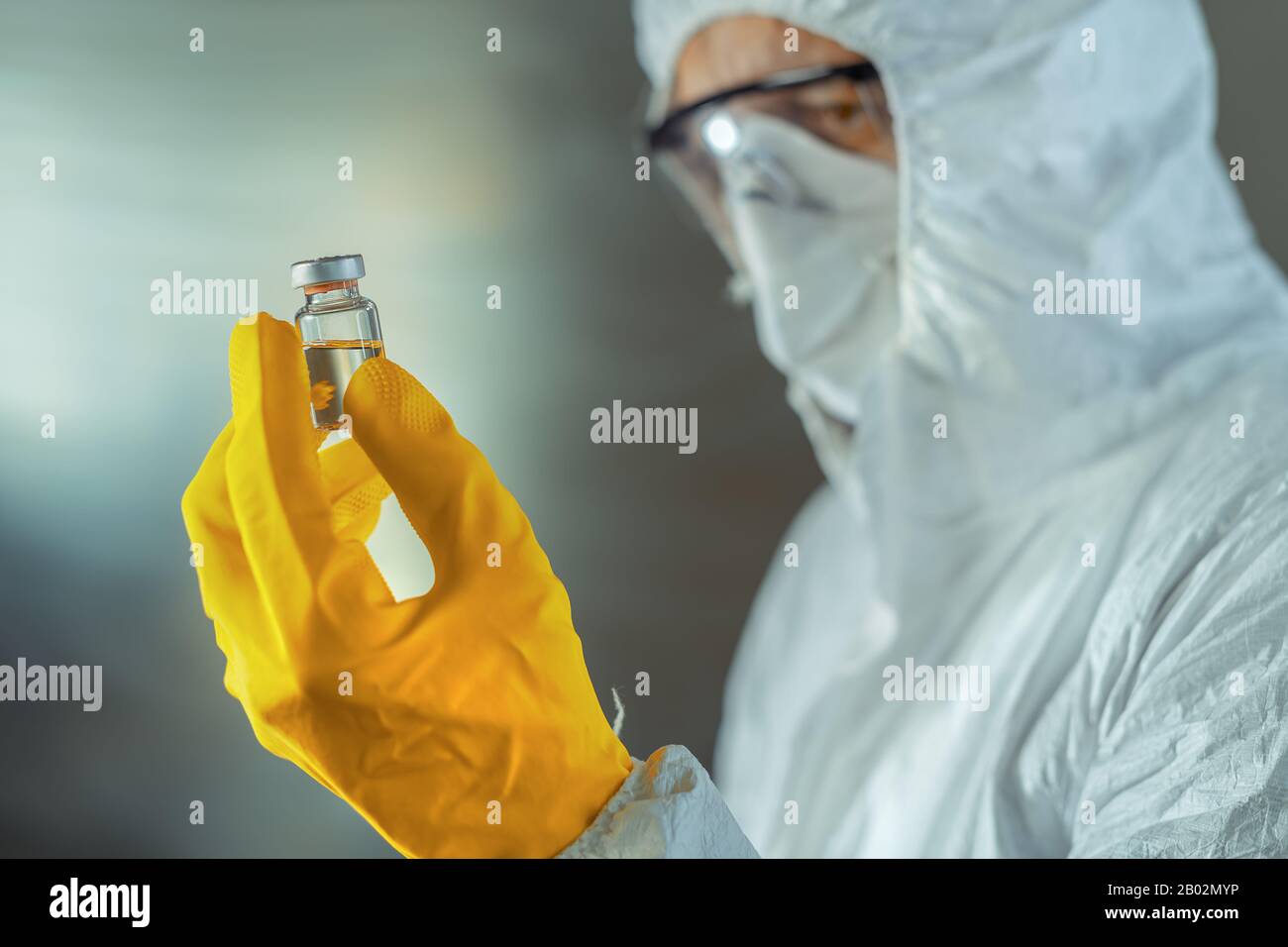 Operatore medico che tiene il flacone sterile di siero di vaccino, fuoco selettivo Foto Stock