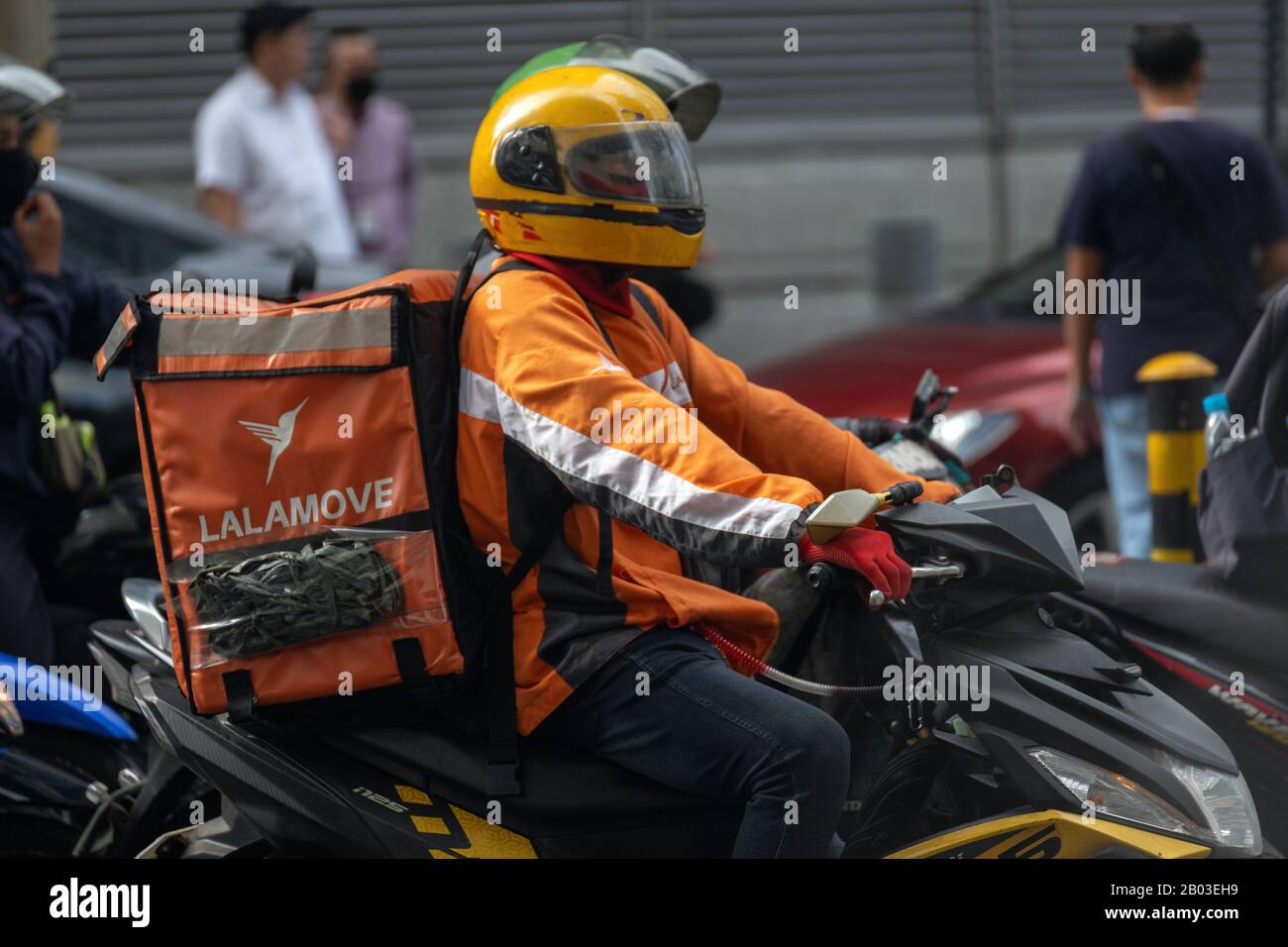 Manila, Filippine - 3 febbraio 2020: Motociclista di consegna nel traffico sulle strade di Makati Foto Stock