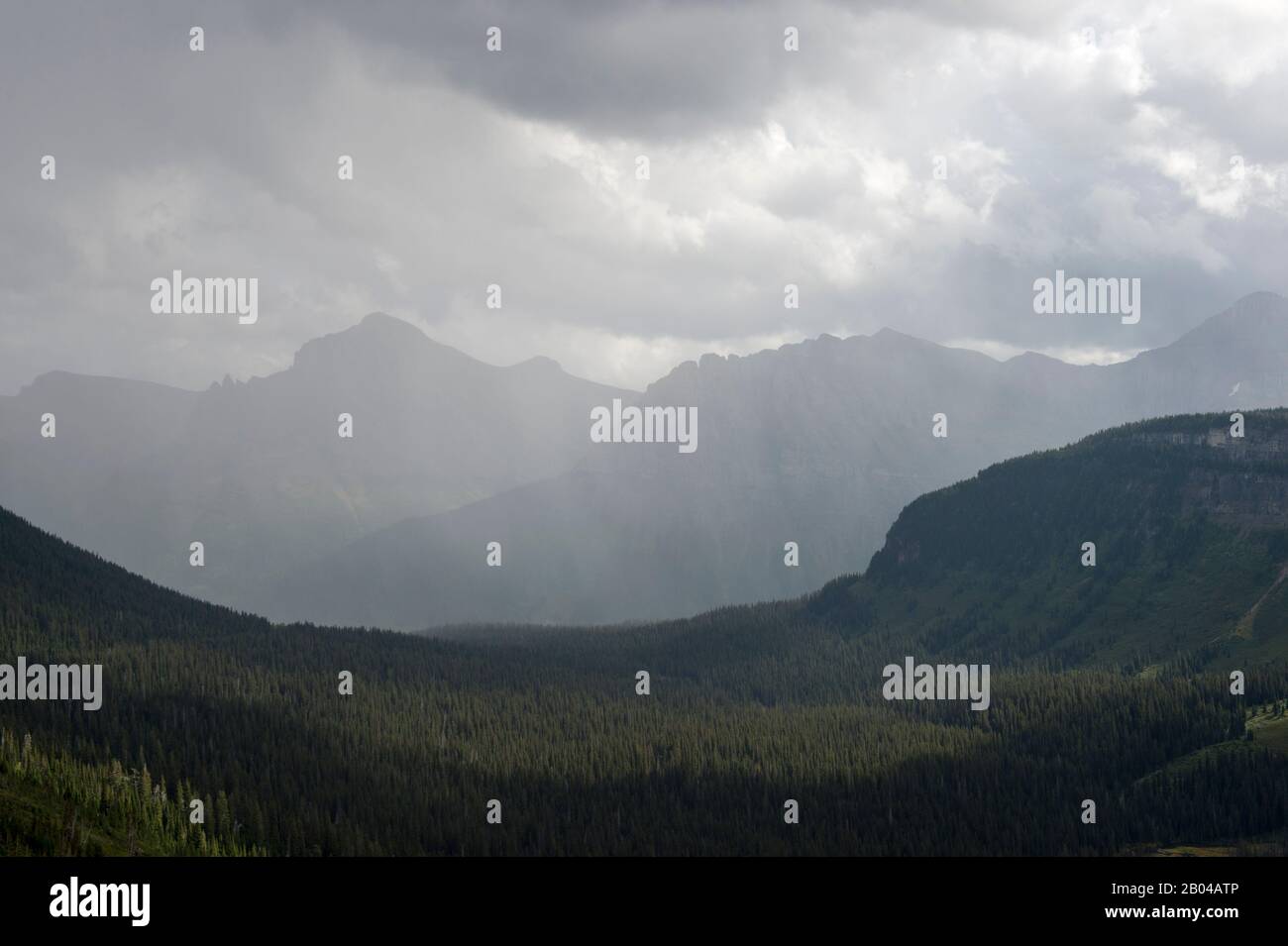 Vista delle montagne con nuvole di pioggia dalla Strada Del Sole Vicino al Logan Pass nel Glacier National Park, Montana, Stati Uniti. Foto Stock