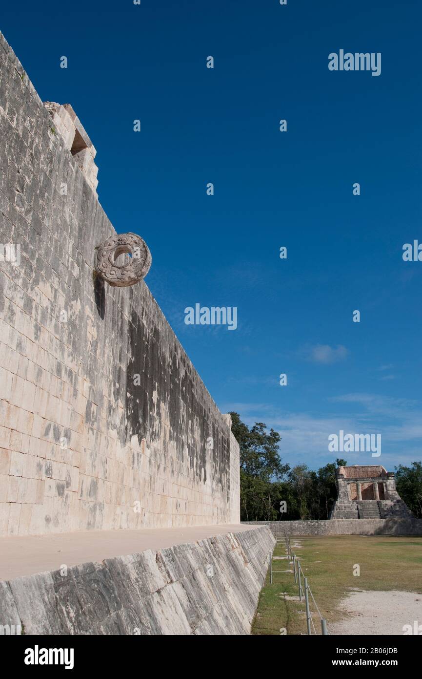 MESSICO, PENISOLA DELLO YUCATAN, VICINO A CANCUN, ROVINE MAYA DI CHICHEN ITZA, IL GRANDE CAMPO DA PALLA, ANELLO DI PIETRA CON TEMPIO DELL'UOMO BARBUTO SULLO SFONDO Foto Stock