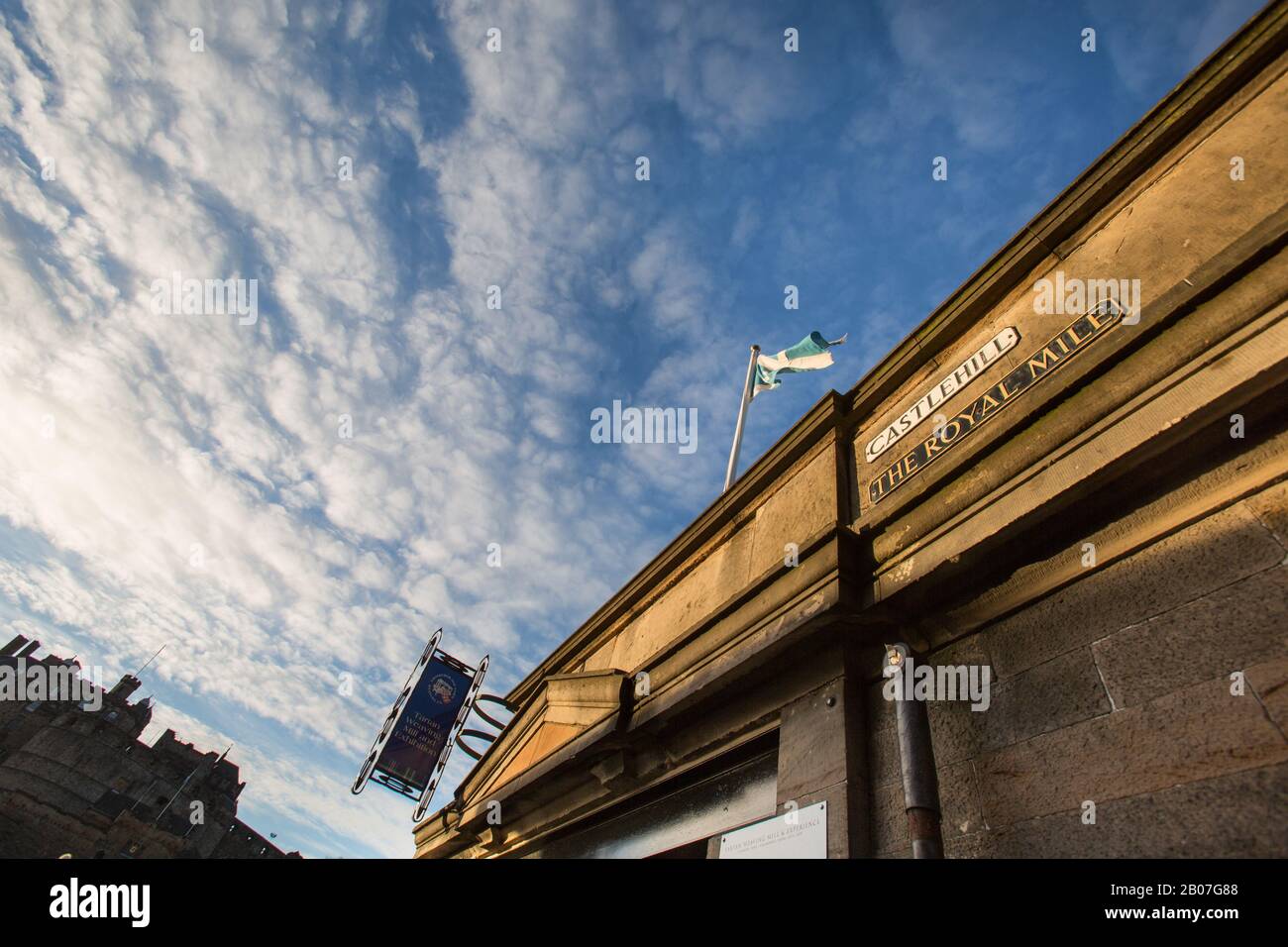 Città Di Edimburgo, Scozia. Pittoresca vista ad angolo di un negozio di fronte alla cima del Royal Mile di Edimburgo, con il Castello di Edimburgo sullo sfondo. Foto Stock