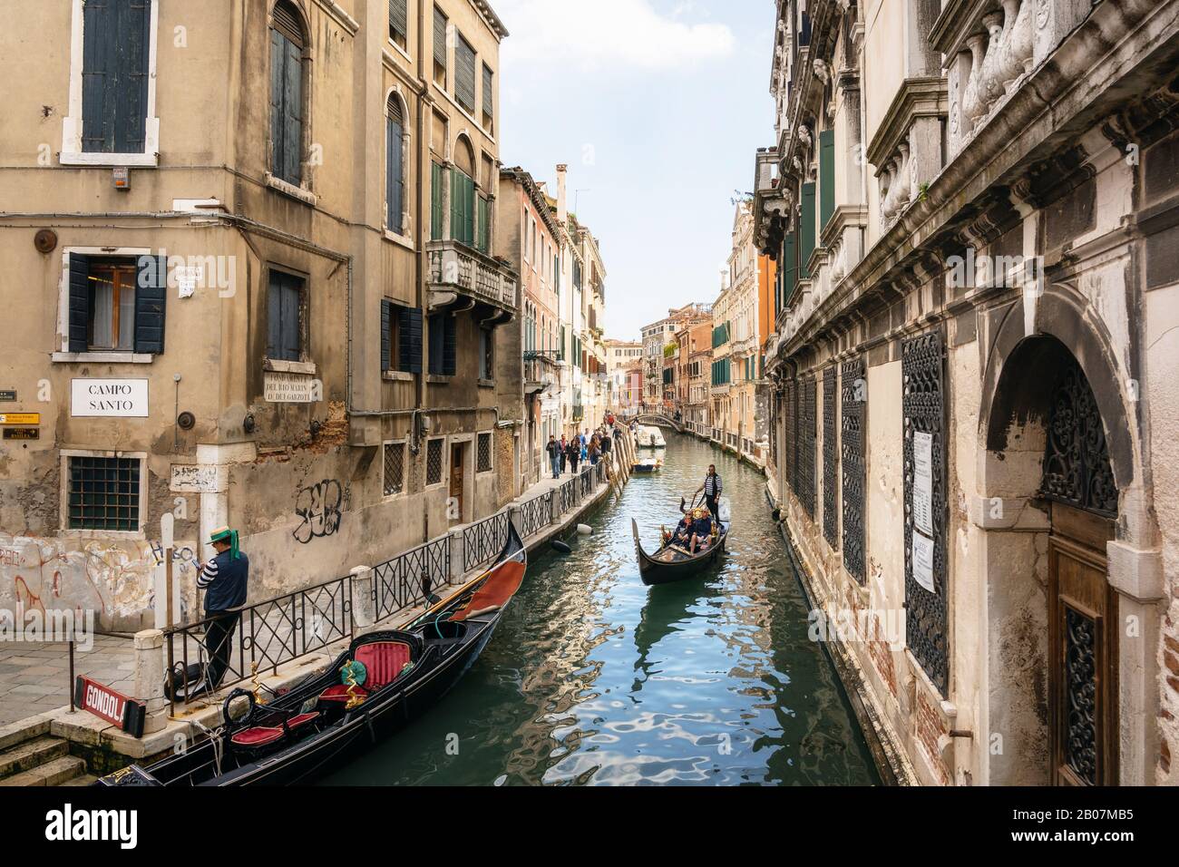 Venezia, Italia - 9 Maggio 2019: gondoliere veneziano sterline in gondola attraverso stretto canale Acque di Venezia Italia Foto Stock