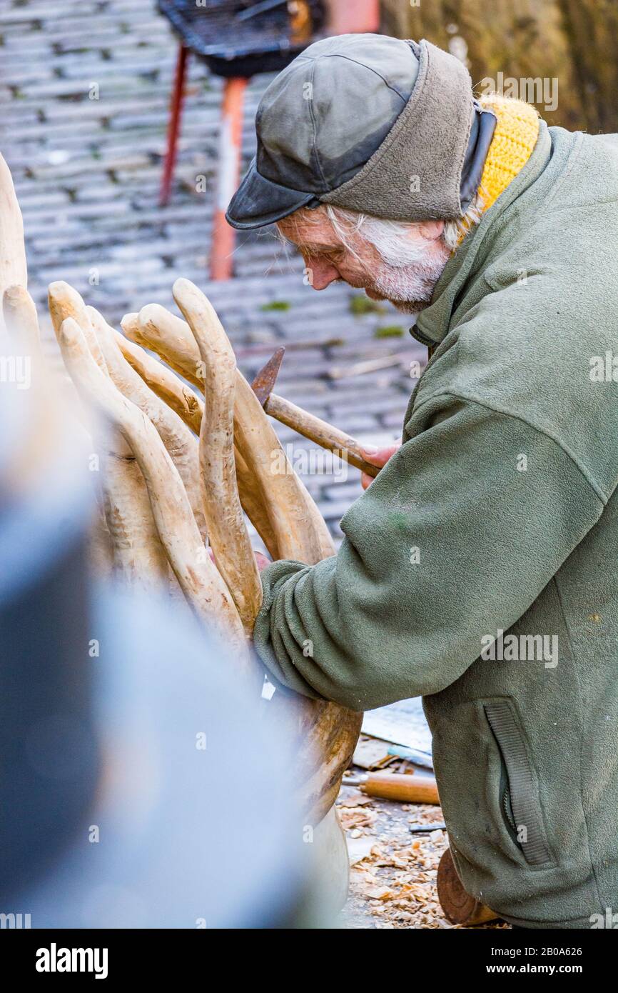 Utrecht, Paesi Bassi - 06 Gennaio 2020. Carver di legno che lavora sulla strada accanto al canale d'acqua Foto Stock