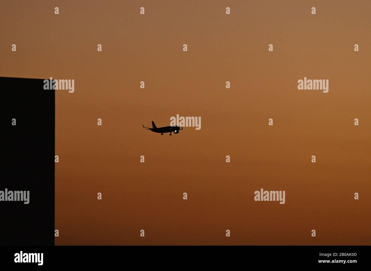 Un aereo atterra all'Aeroporto Internazionale di Orlando al tramonto. Foto Stock