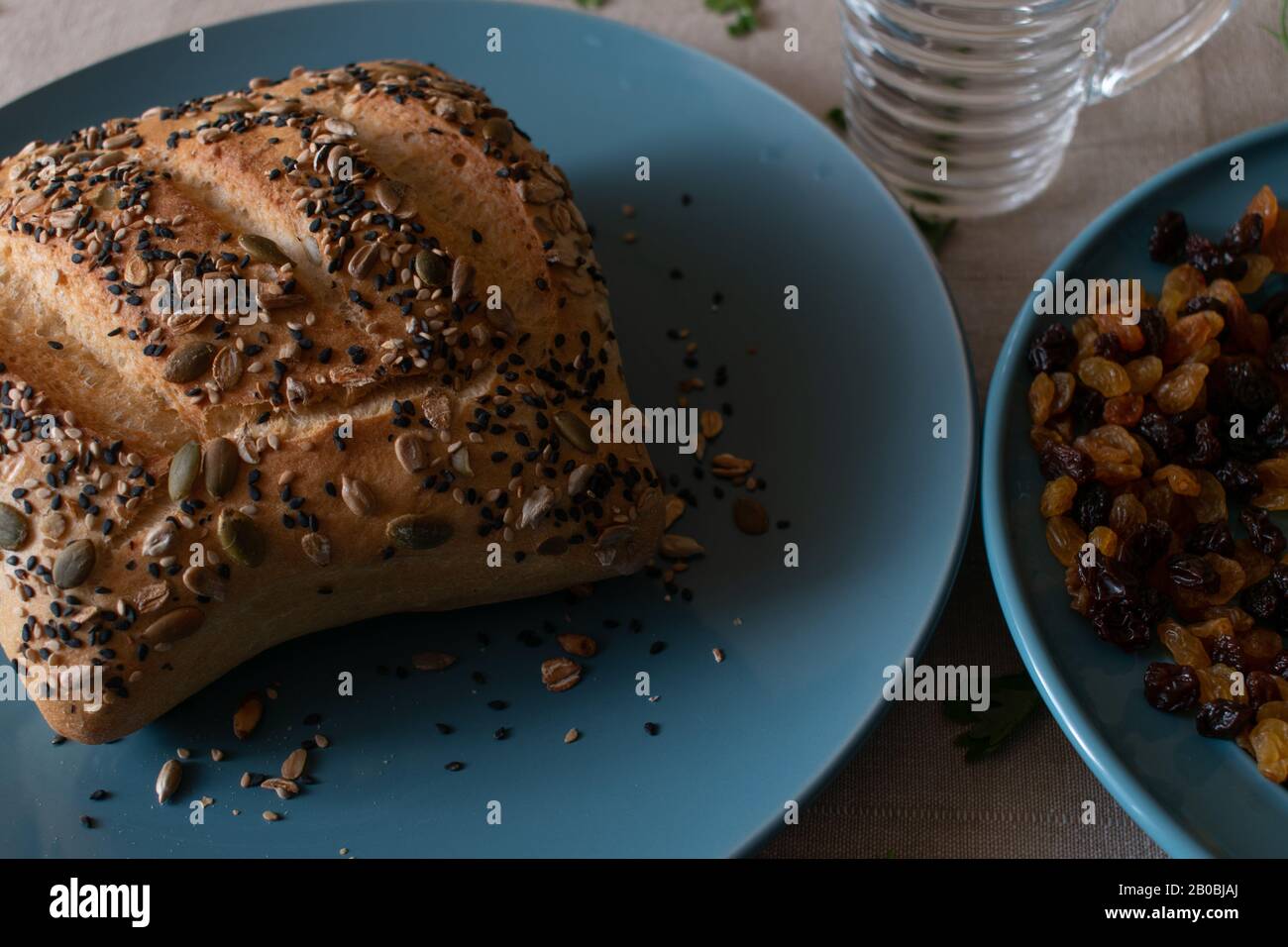 pane lastricato su un piatto blu con illuminazione scura Foto Stock