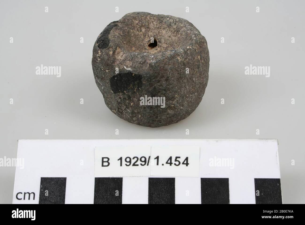 Una pietra rettangolare con angoli arrotondati. Il fondo e la parte superiore sono a forma di ciotola. Funzione sconosciuta., pietra, pietra, basalto, H 4 cm, D 5,4 cm, Palestina Foto Stock