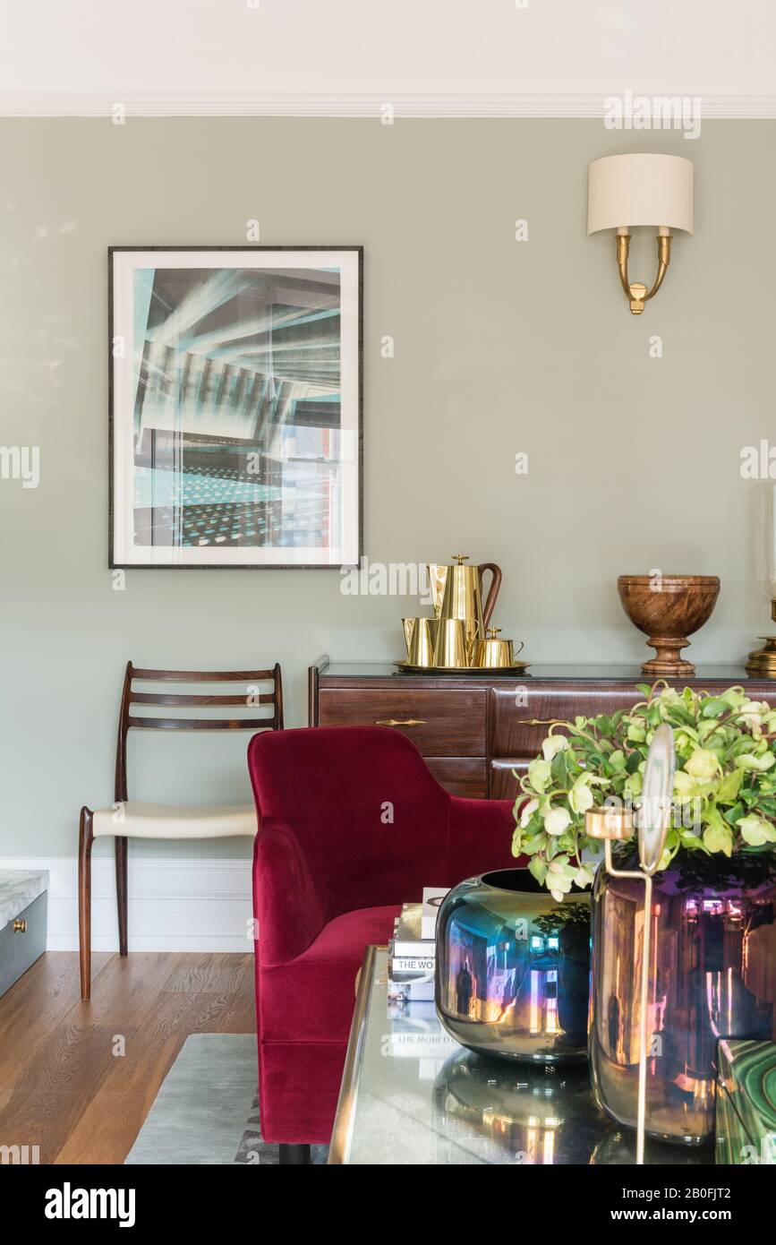 Mix di pezzi vintage e contemporanei, sideboard Yoko e poltrona su misura in velluto rosso Foto Stock