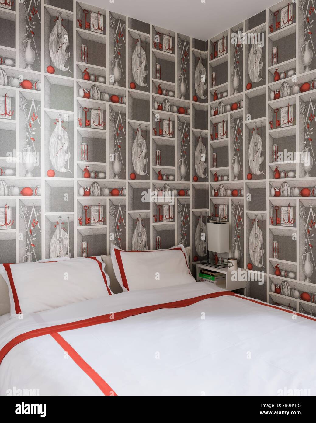 Carta da parati trompe l'oeil con biancheria rossa e idromassaggio su letto matrimoniale. Foto Stock