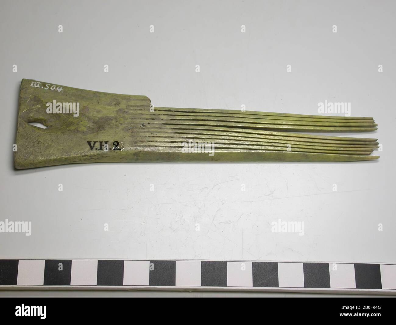 Pettine singolo su un lato. Tipo: Pettine con manico corto e denti lunghi. Decorazione: Assente. Forma: Pettine allungato. Questo pettine è realizzato in un unico pezzo e non più stratificato. L'impugnatura è angolare. Denti: 10 (denti interi). Denti rotti: 2. Numero di denti originale: 12. Vi è un foro nella lama del manico, pettine, organico, osso, l = 14,7 cm e b = 3,7 cm., 700-1500, Paesi Bassi, Friesland, Súdwest Fryslân, Hartwerd, terp Foto Stock