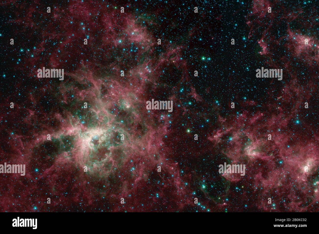 Washington, Stati Uniti. 20th Feb, 2020. Questa immagine del telescopio spaziale Spitzer della NASA mostra la Tarantula Nebula in tre lunghezze d'onda di luce infrarossa, ciascuna rappresentata da un colore diverso. La Tarantula Nebula è stata uno dei primi obiettivi studiati dall'osservatorio a infrarossi dopo il suo lancio nel 2003, e il telescopio l'ha rivisitata molte volte da allora. Ora che Spitzer è stato ritirato il 30 gennaio 2020, gli scienziati hanno generato una nuova visione della nebulosa dai dati Spitzer. NASA/UPI Credit: UPI/Alamy Live News Foto Stock