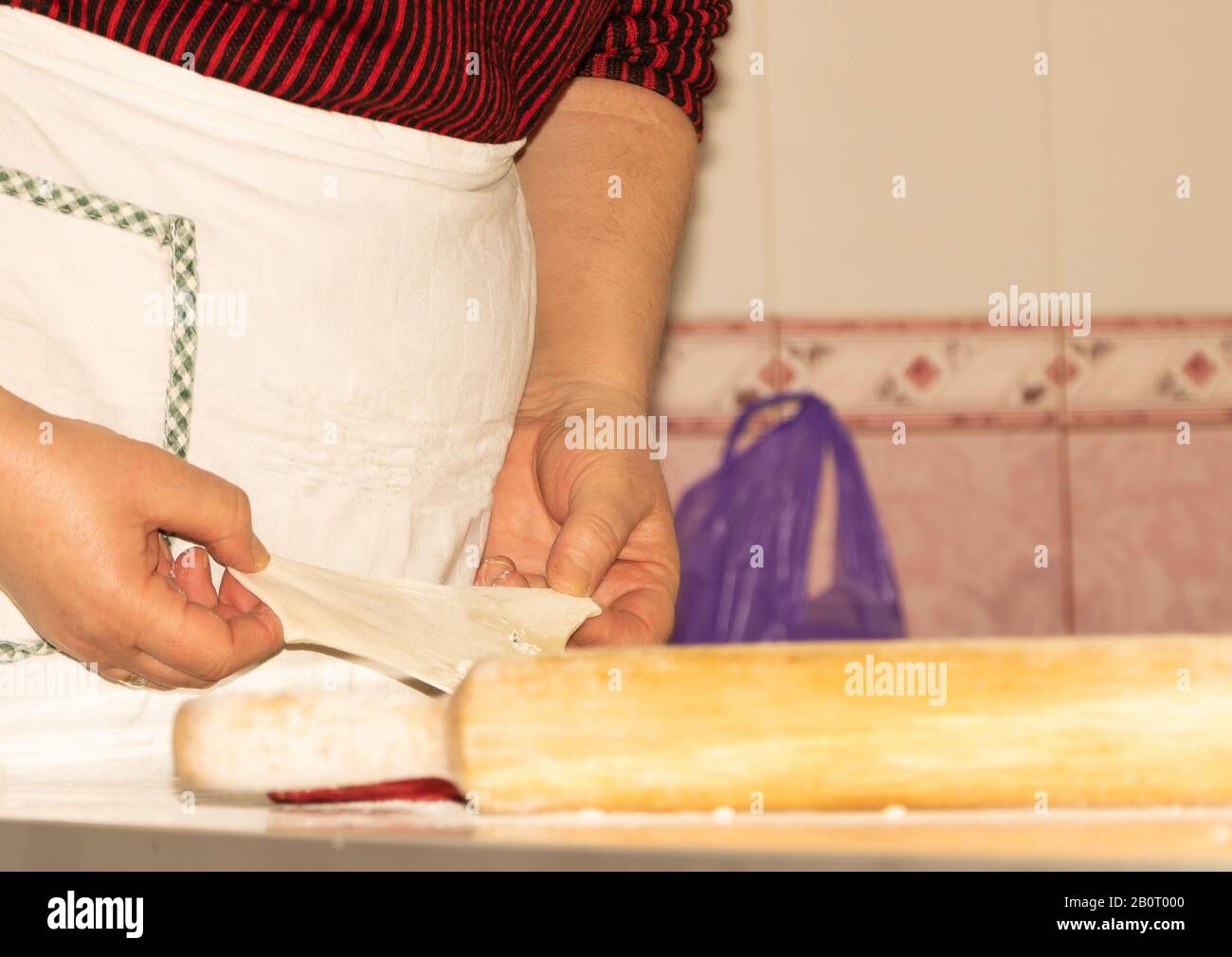 Concetto di cottura dell'impasto. Mani femminili che cucinano cibo di pasta Foto Stock