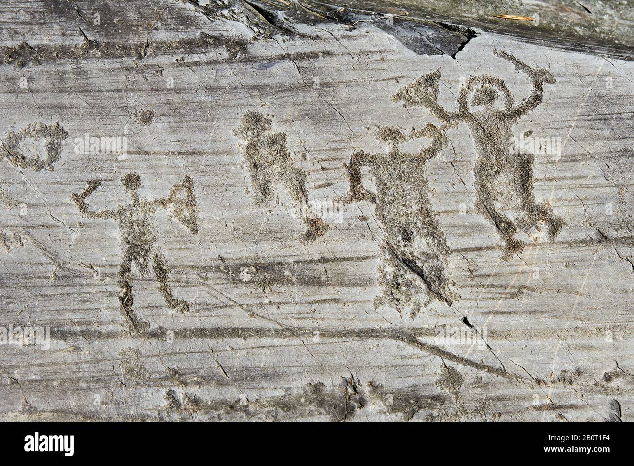 Petroglyph, scultura in roccia, di un gruppo di guerrieri che indossano un casco e portano una spada e uno scudo. Scolpito dagli antichi Camuni nell'iro Foto Stock