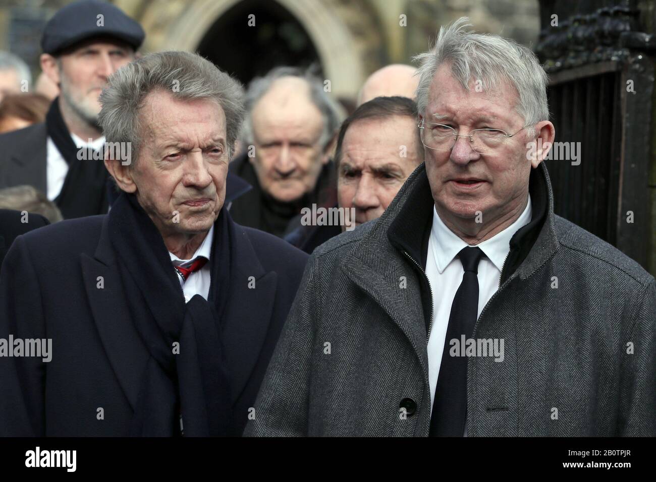 Denis Law e Sir Alex Ferguson al di fuori della chiesa parrocchiale di San Patrizio, Coleraine dopo il funerale dell'ex portiere del Manchester United e dell'Irlanda del Nord Harry Gregg. Foto Stock