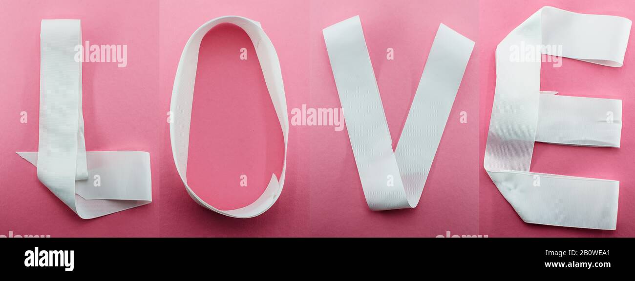 Parola Amore scritto nastro bianco o nastro su sfondo rosa. San Valentino, Donna, matrimonio, Festa della mamma, anniversario biglietto di auguri. 14th febbraio. Foto Stock