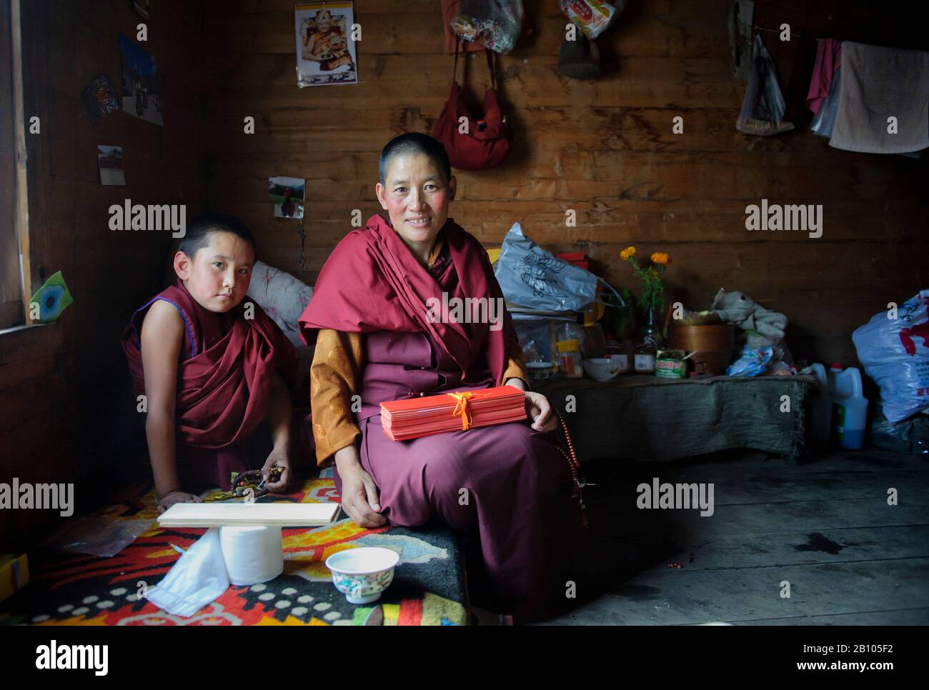 I monaci tibetani vivono in comunità. I loro chiostri sono molto semplici e la loro appartenenza è limitata ad abiti, alcune figure religiose, un letto di legno e le lenzuola di preghiera. Kasongdu villaggio. Altopiano tibetano remoto Foto Stock