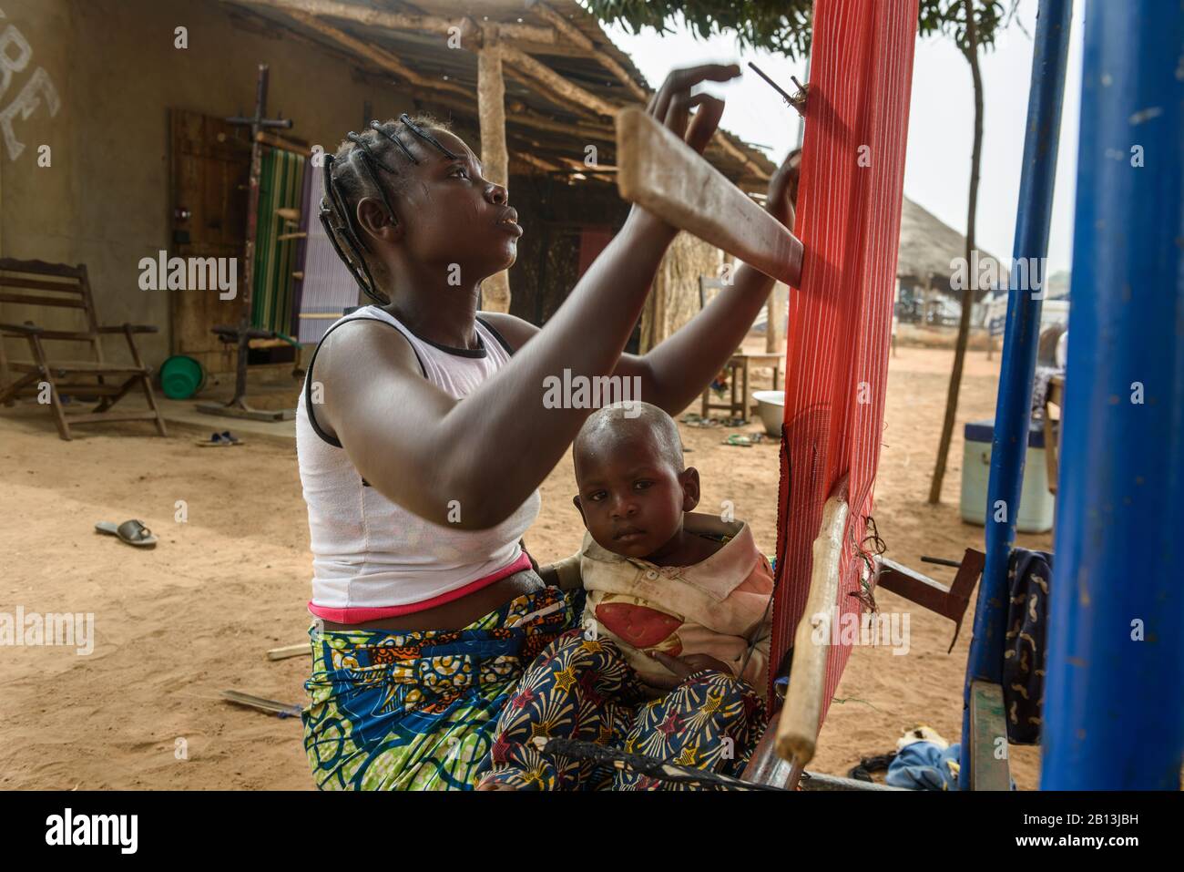 Ragazze e donne che lavorano sui loro telai in un villaggio del Benin settentrionale, Africa Foto Stock
