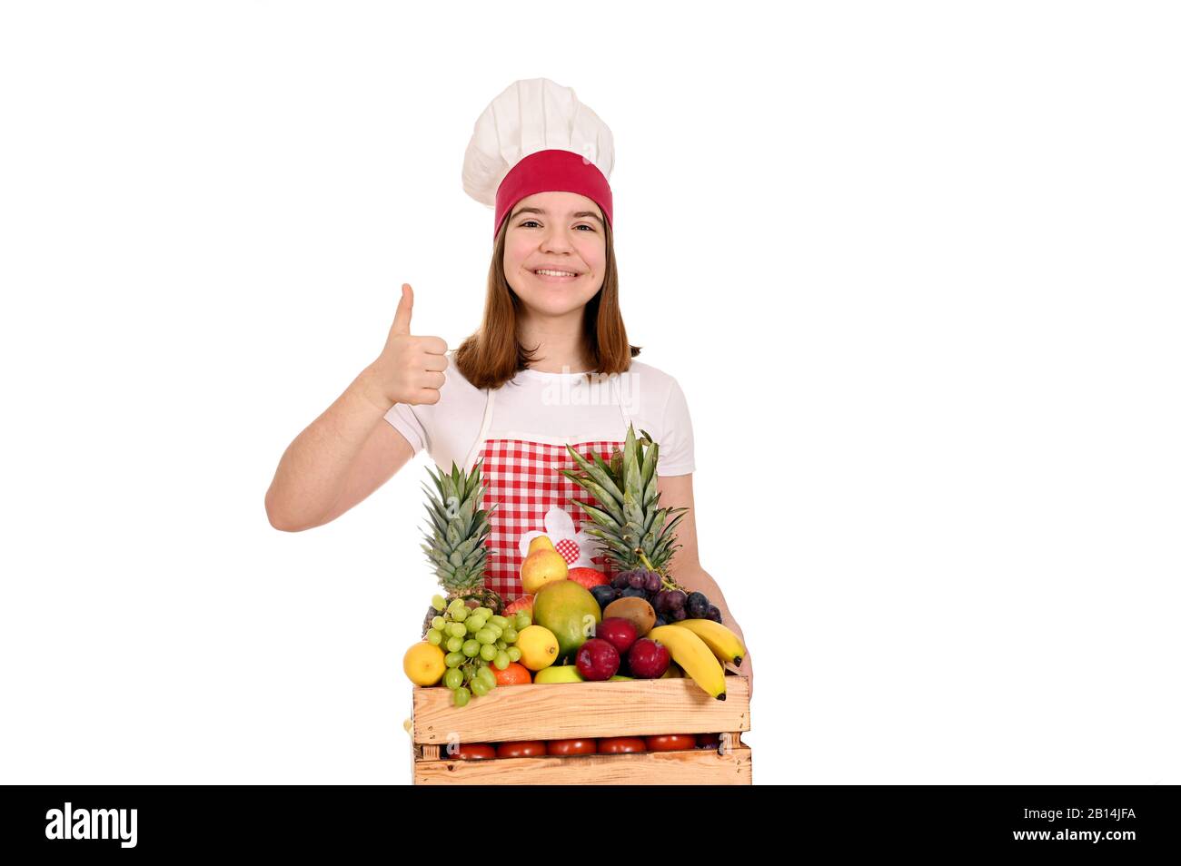 cuoco femminile con frutta e pollice in su Foto Stock