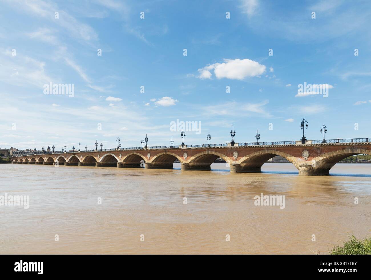 Francia, Gironde, Bordeaux, Sky sopra Pont de Pierre che si estende attraverso il fiume Garonna Foto Stock
