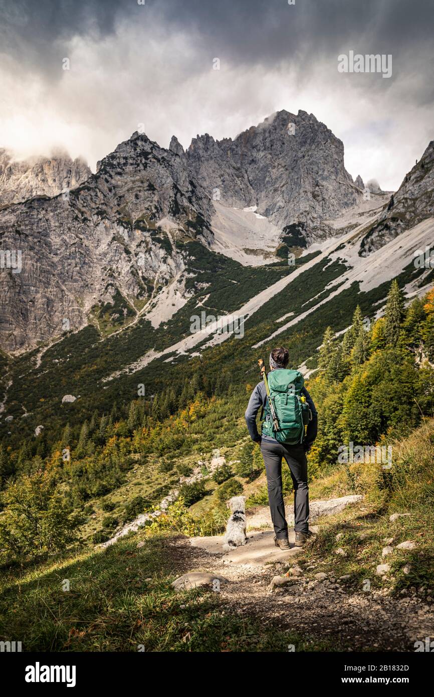 Donna in un viaggio a piedi a Wilder Kaiser godendo della vista, Kaiser montagne, Tirolo, Austria Foto Stock