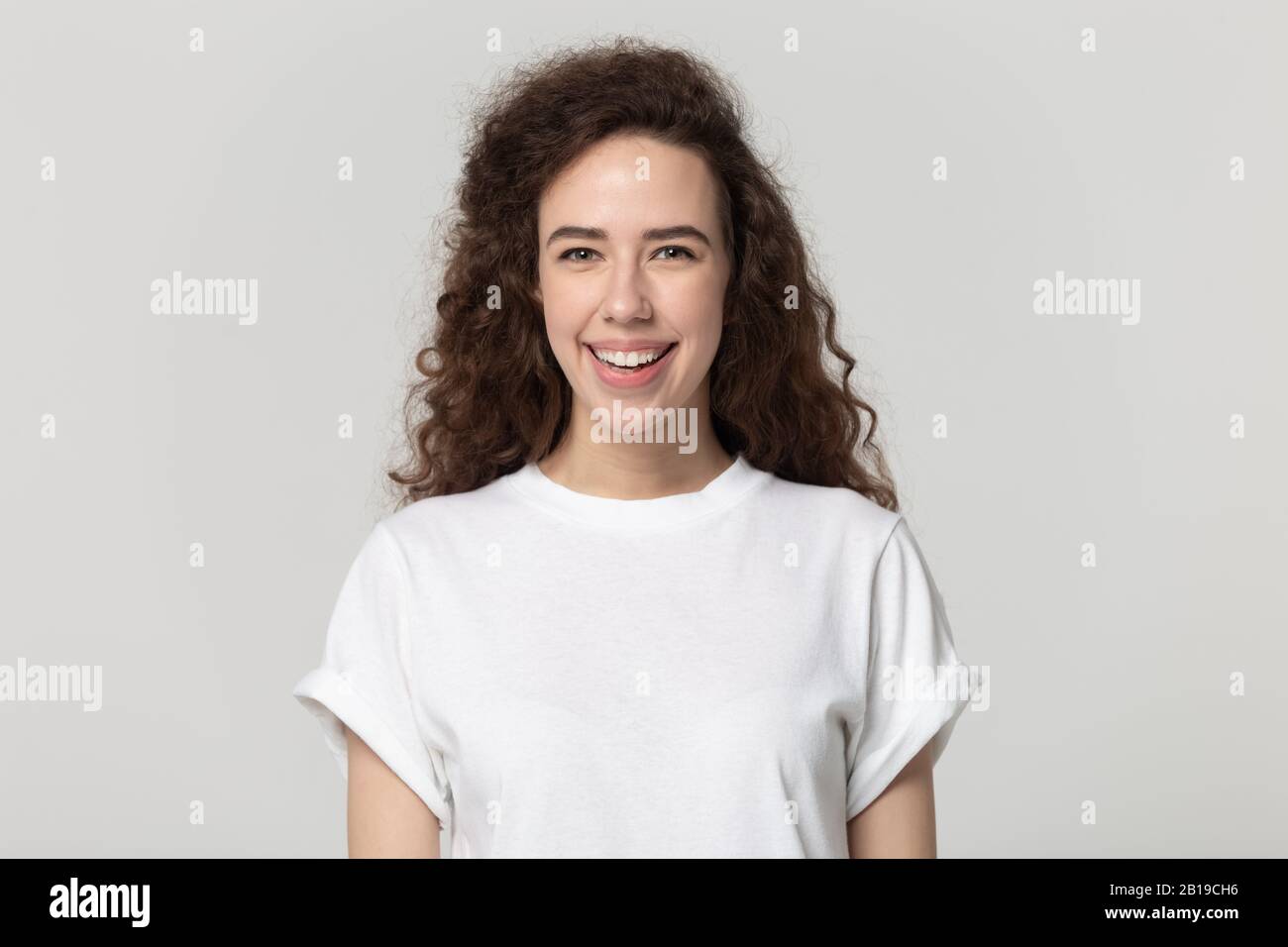 Testa ripresa primo piano ritratto millenario felice sorridente donna attraente. Foto Stock