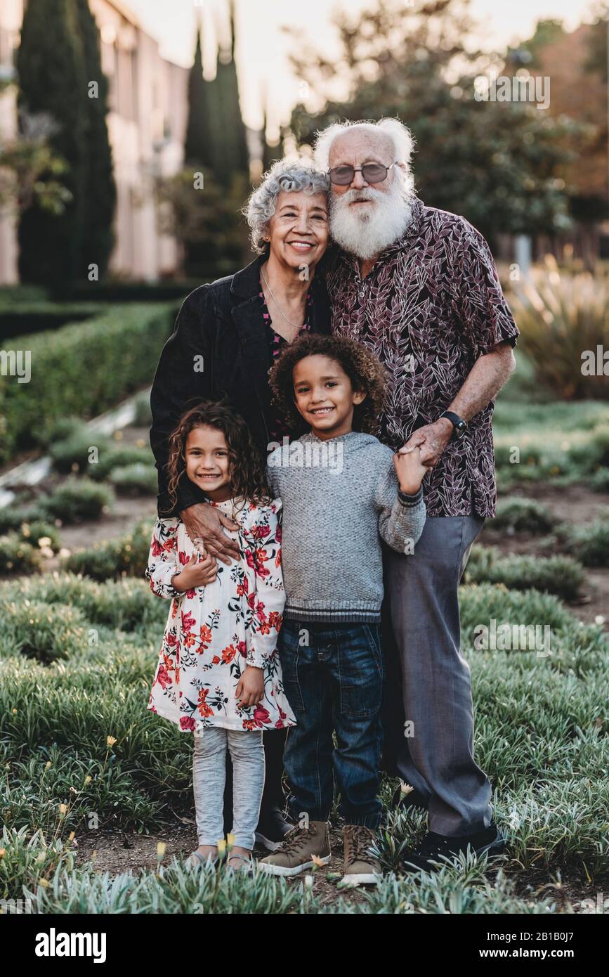 Ritratto tradizionale di nonni e nipoti in piedi Foto Stock