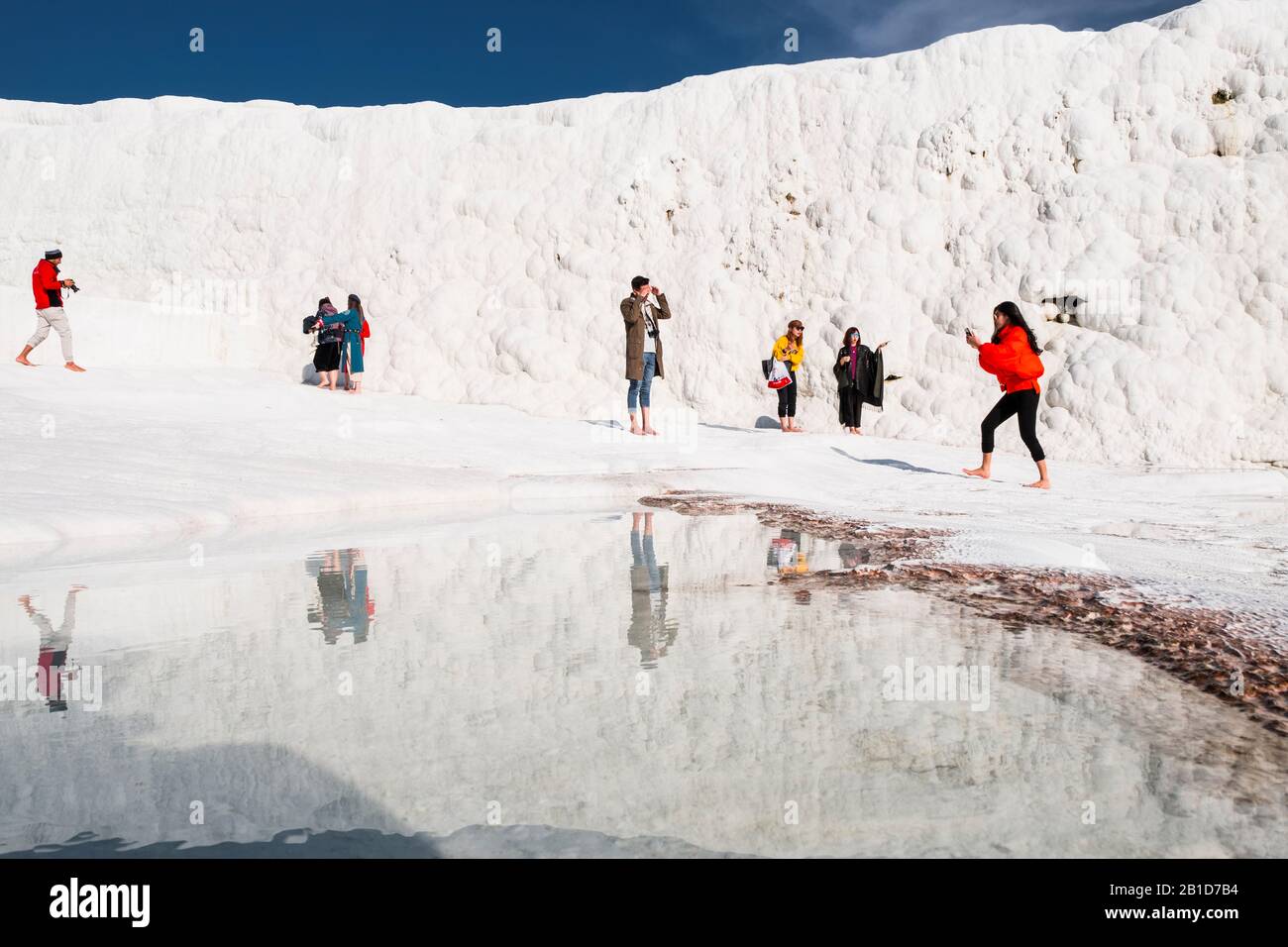 Formazioni di travertino a Pamukkale e turisti Foto Stock