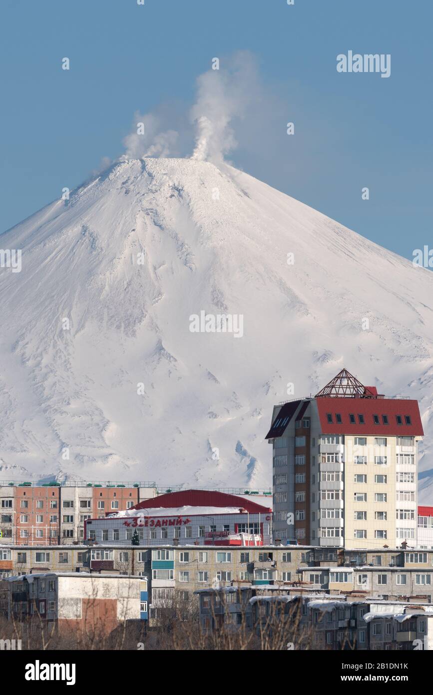 Paesaggio invernale della città di Petropavlovsk-Kamchatsky, fumarole attività del vulcano Avacha attivo in giornata di sole con cielo blu chiaro. Penisola di Kamchatka Foto Stock