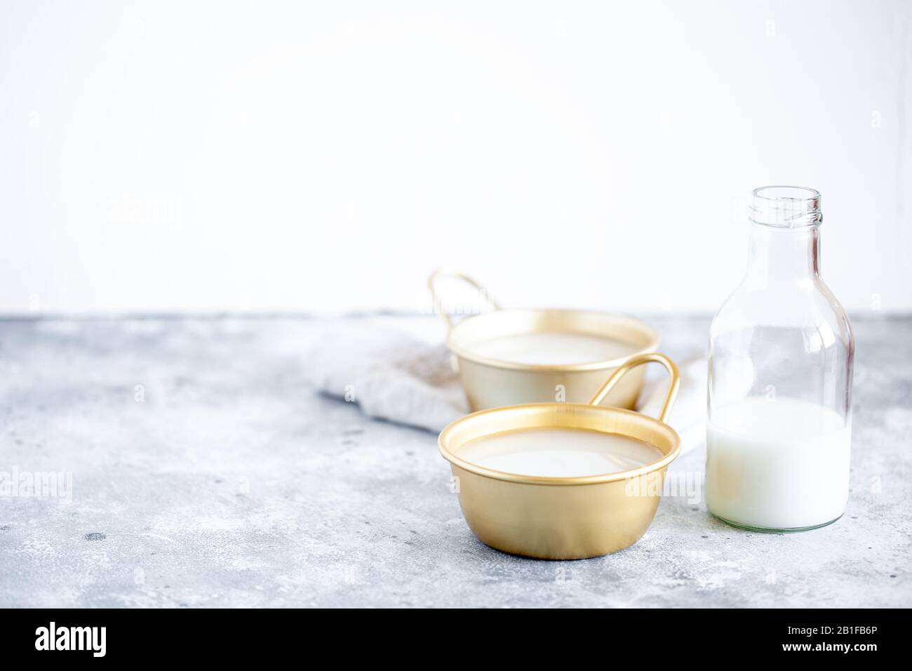 Il riso Makgeolli è uno dei più antichi alcolici tradizionali coreani fermentati in tazza e bottiglia di vetro. Bevanda sana asiatica Foto Stock