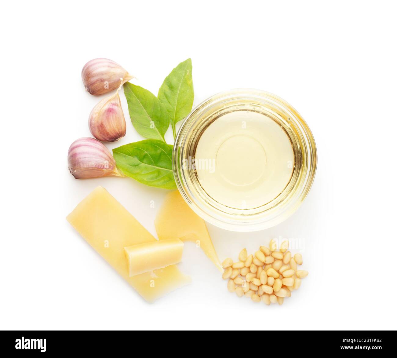 Ingredienti per cucinare il pesto isolato su fondo bianco. Set di prodotti per pesto tradizionale di salsa italiana. Basilico, aglio, olio d'oliva, pino Foto Stock