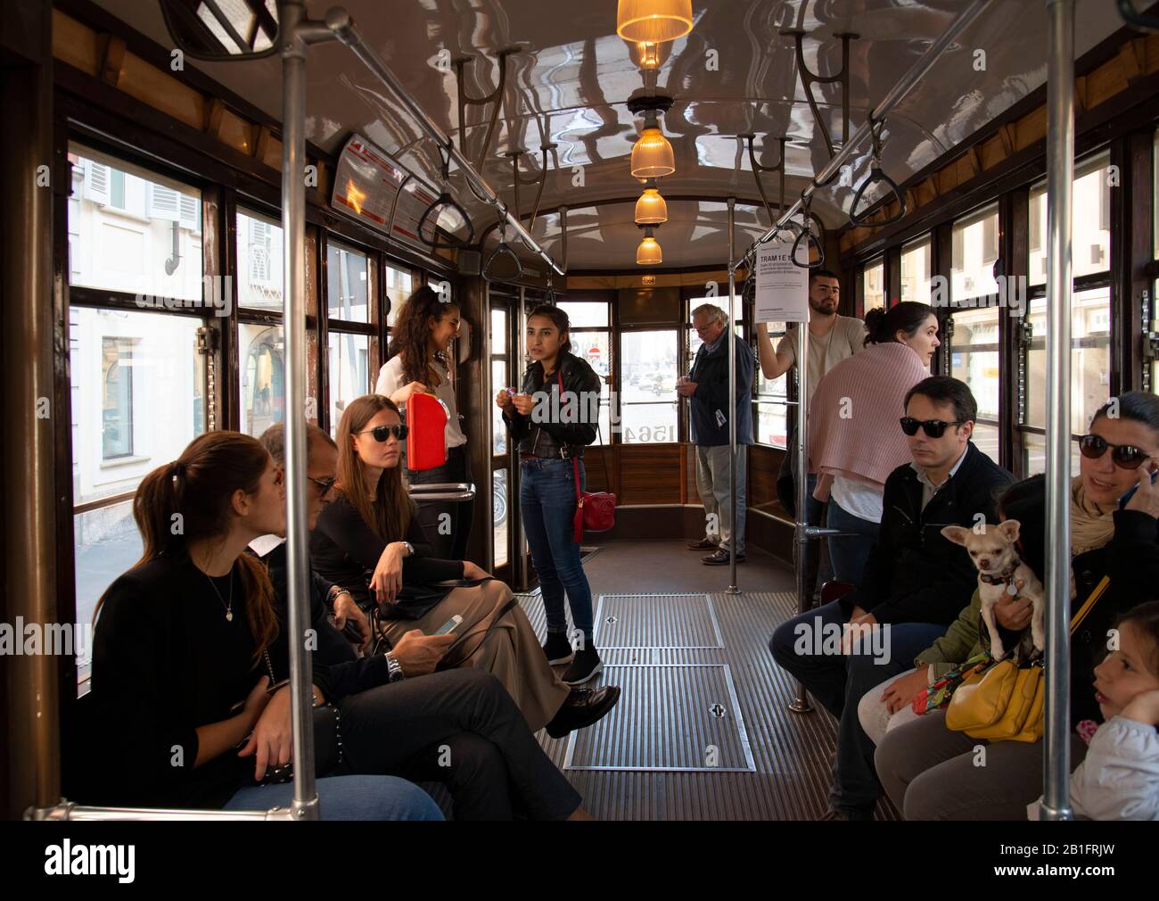 Passeggeri che viaggiano in un vecchio tram elettrico a Milano, Lombardia, Italia, Europa Foto Stock