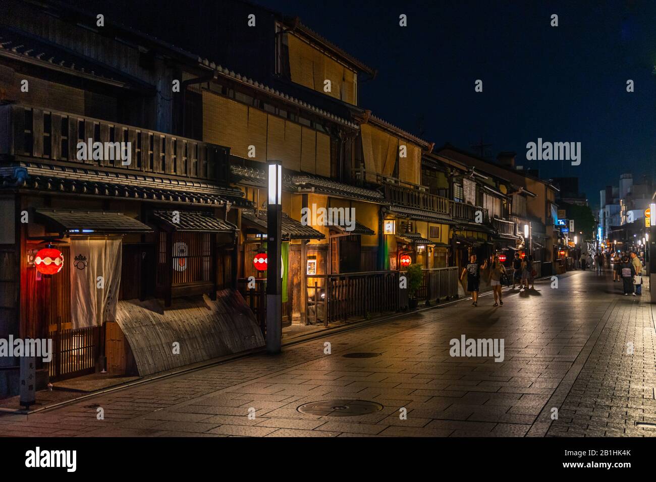 Vista notturna della casa mercantile di legno machiya fiancheggiata da una strada a Gion, il quartiere più famoso di Kyoto Foto Stock