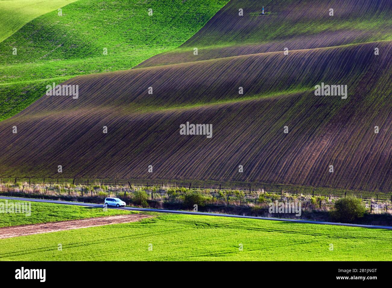 Paesaggio rurale con auto e campi agricoli sulle colline di primavera in Moravia del sud regione, Repubblica Ceca Foto Stock