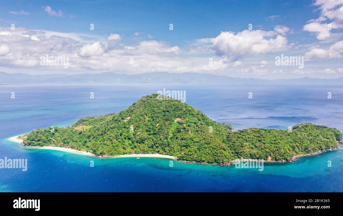 Isola con una spiaggia bianca, vista dall'alto. Isola di Atulayan, Camarines sur, Philippines.Sea paesaggio, mare blu e isola tropicale con una giungla. Concetto di vacanza estiva e di viaggio. Foto Stock